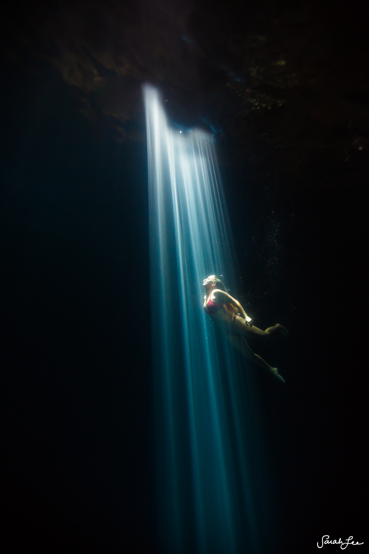  Spectacular light rays created naturally by the sunlight at high noon as it hit one single opening in the roof of this cenote. 