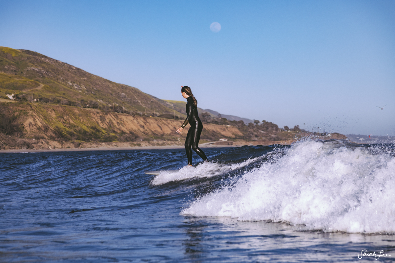 Anna Ehrgott surfing Malibu County