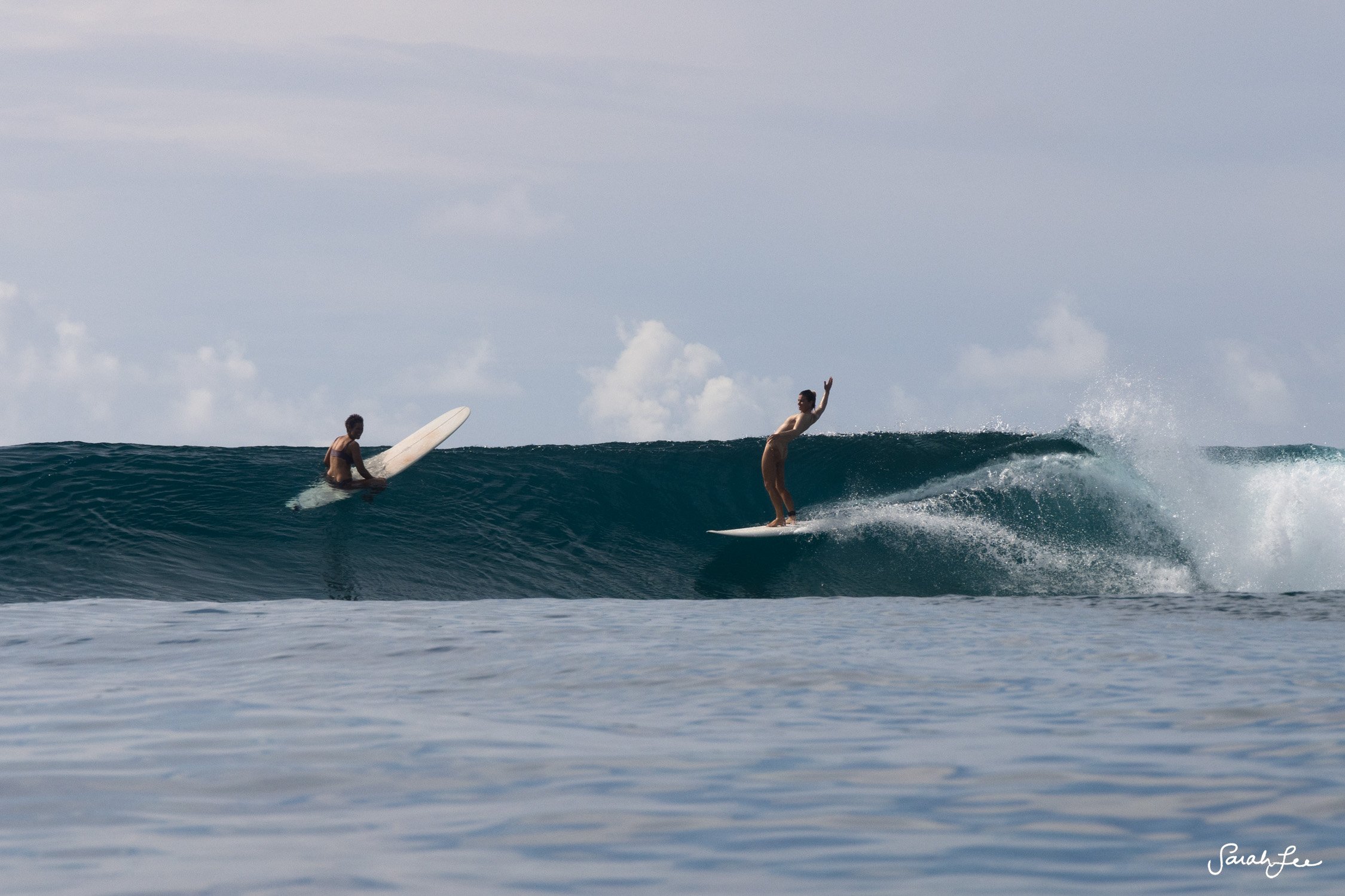 Leah Dawson and Kassia Meador surfing in the Maldives