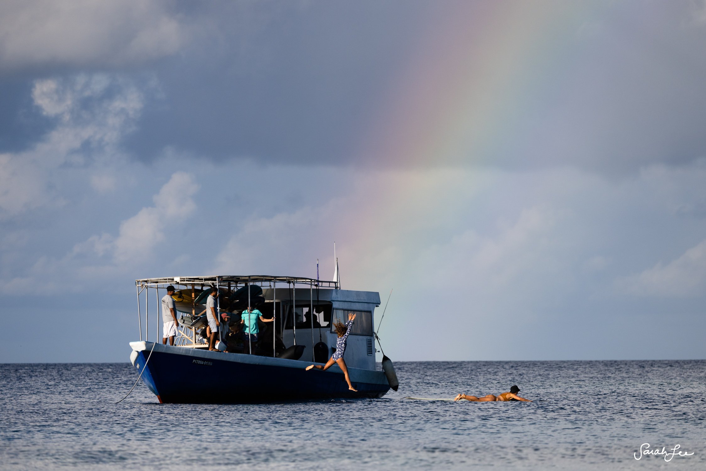 Surf dhoni boat under a rainbow in the Maldives