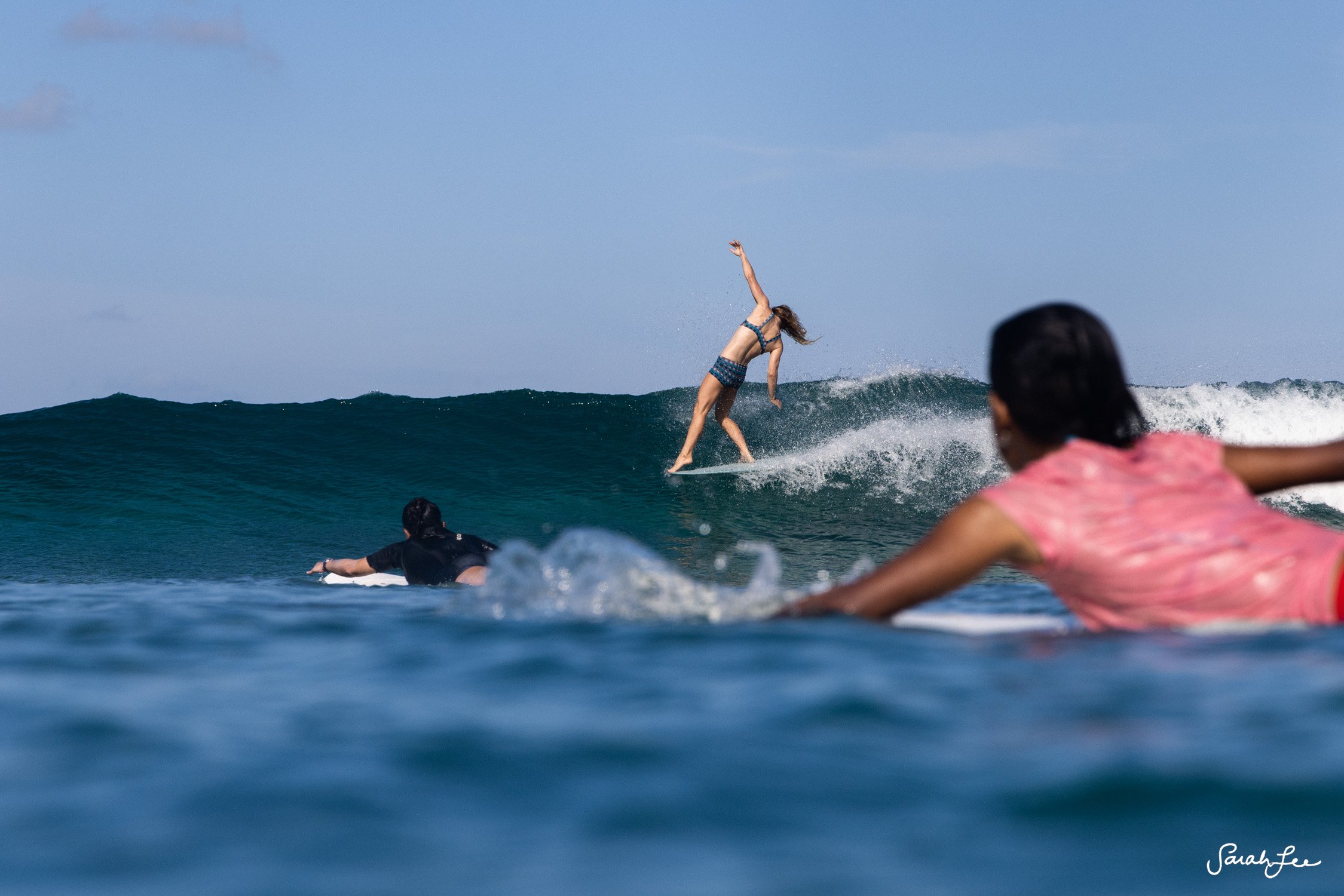 Expressive hang five by longboarder Leah Dawson