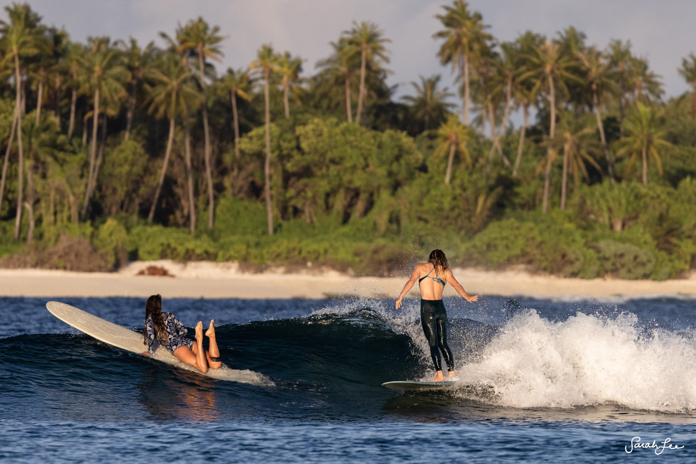 Girls longboarding trip in the Maldives. Leah Dawson wearing SEEA c-skin surf suit.