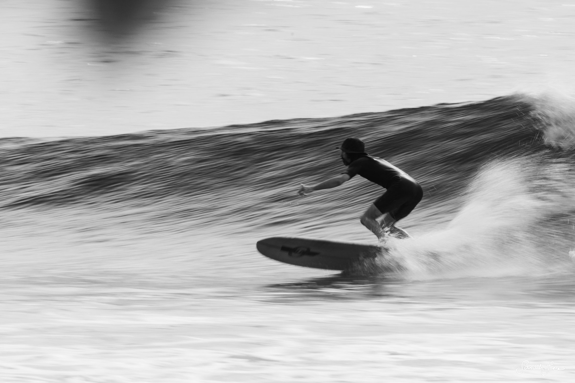 Speed blur of surfer on a wave at Jail Breaks on Himmafushi Island, North Male.