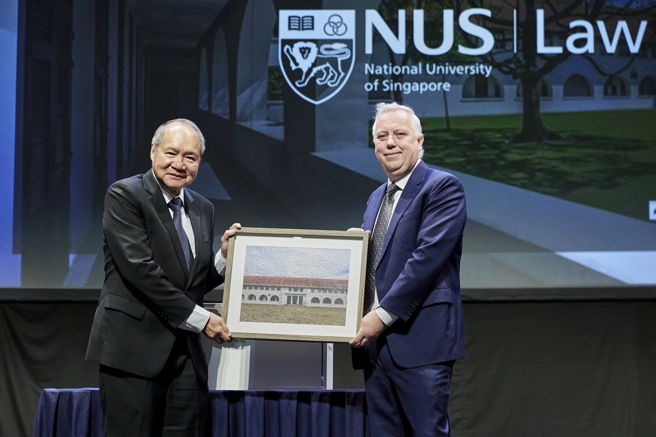 Dean Simester presenting a token of appreciation to Attorney-General Wong