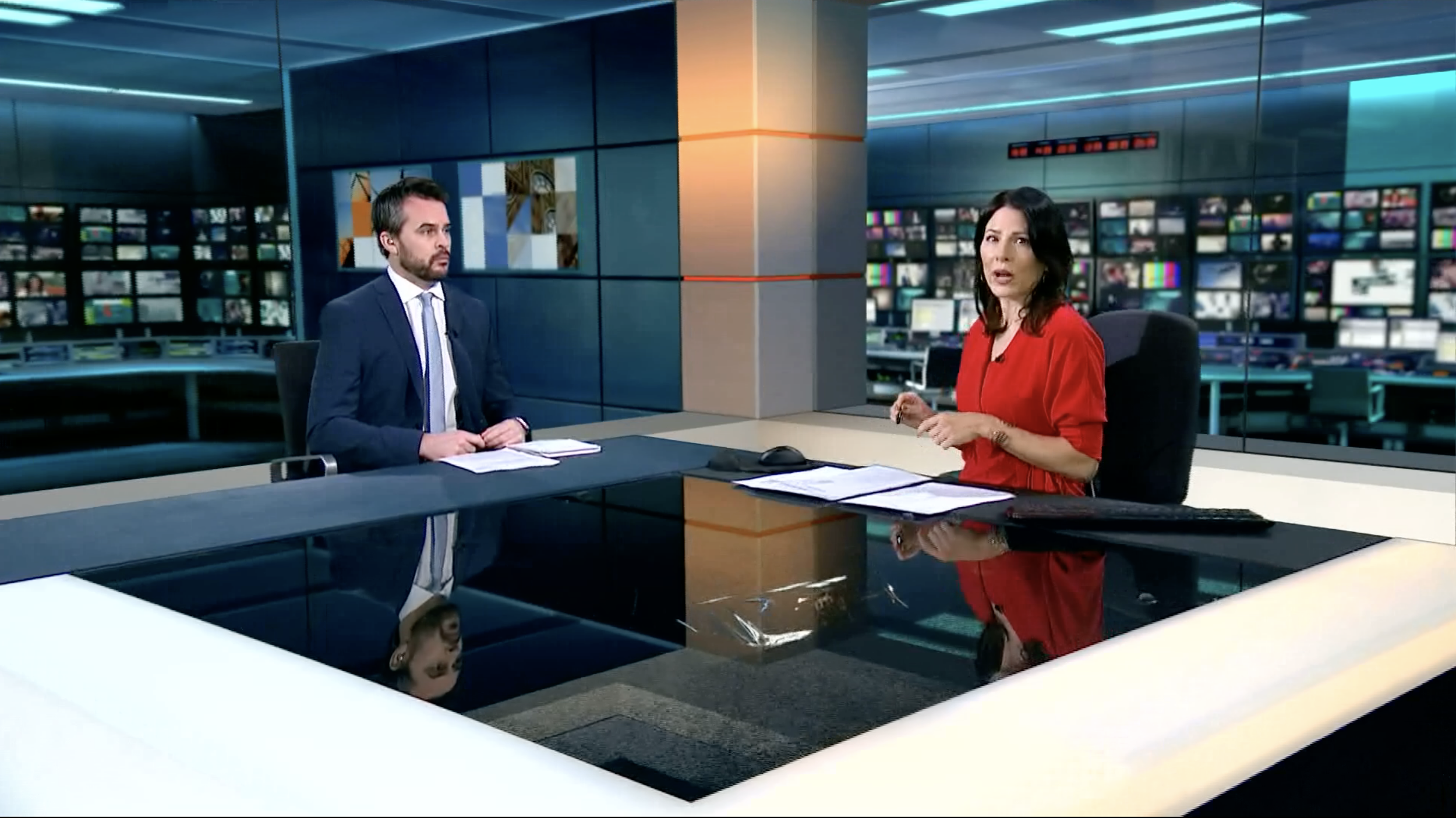 Covering breaking news in the ITV News studio.