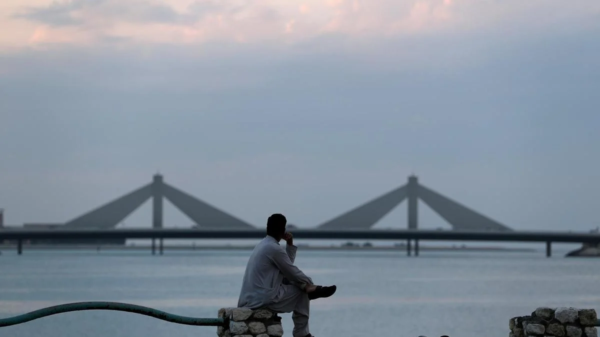 FILE-PHOTO-Man-sits-and-looks-towards-the-Sheikh-Isa-Causeway-in-Manama.jpg