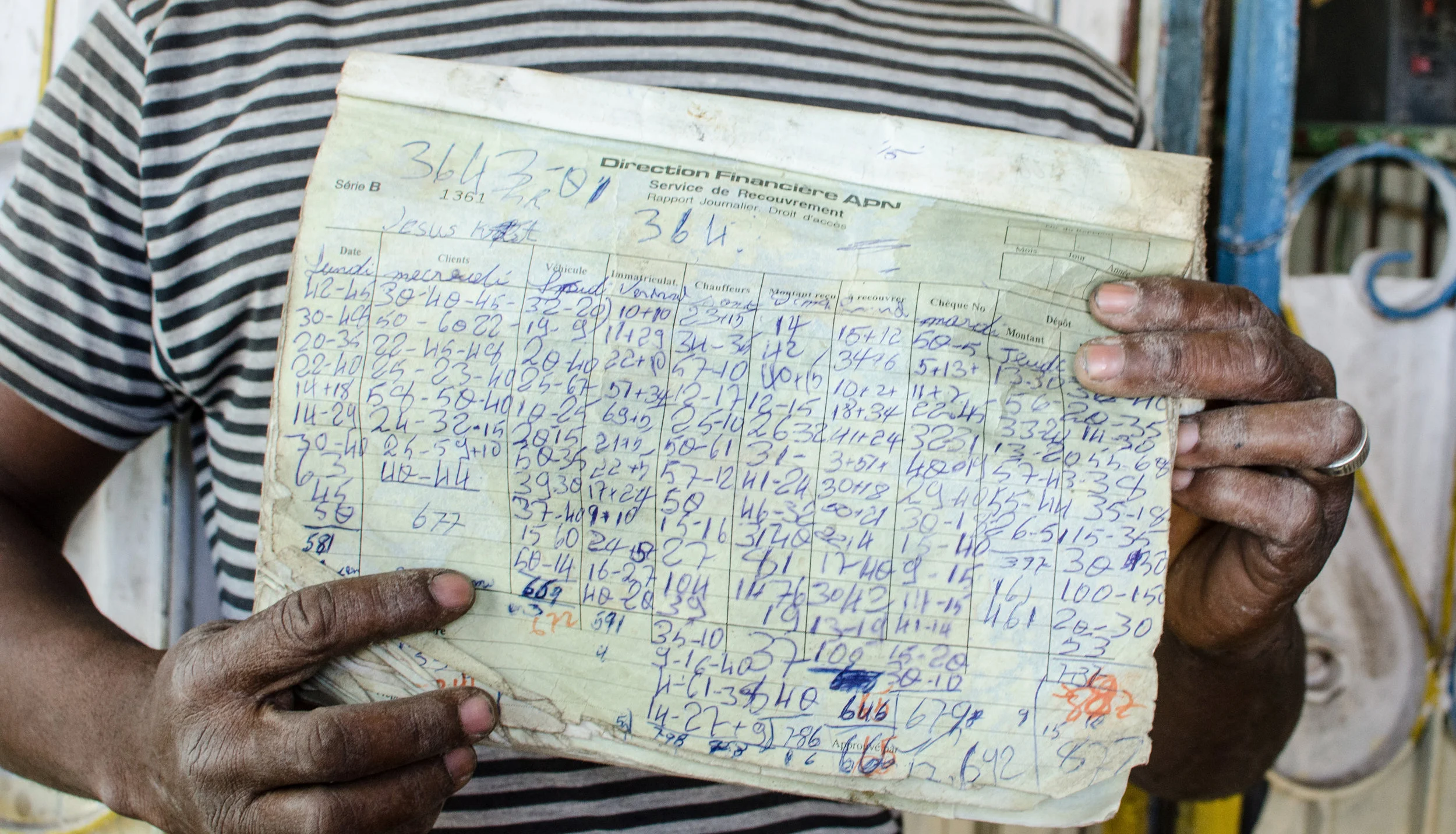 This collection center owner records his transactions in a draft log, then copies the entries to an official ledger at the end of each day’s business