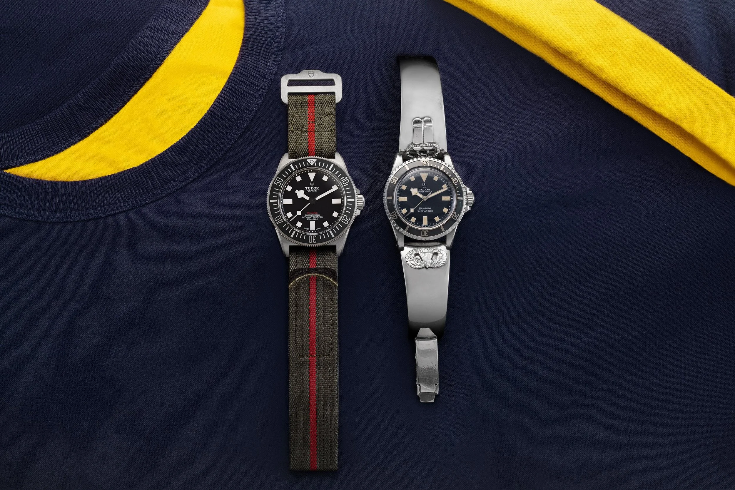 A modern Tudor Pelagos FXD ref. 25717N beside a 1968 Tudor Oyster Prince Submariner ref. 7016 on a Navy SEAL Museum San Diego shirt