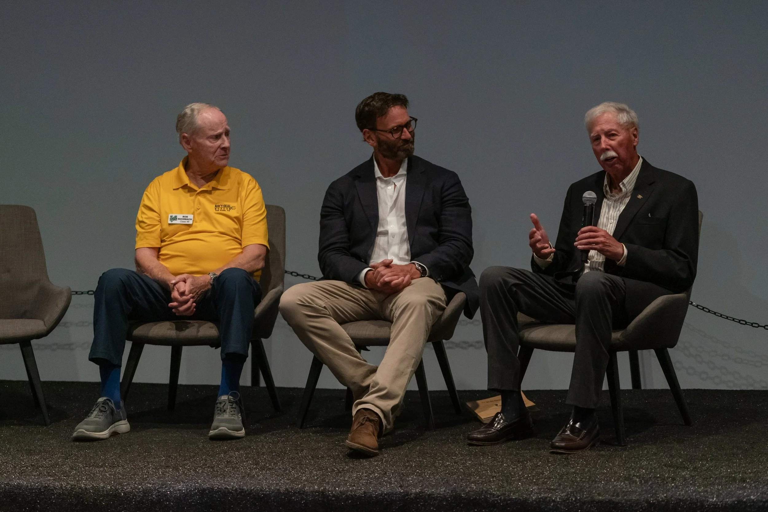Capt. Bob Rohrbach, author Jack Carr and John McLachlan on stage at the Navy SEAL Museum San Diego Tudor event