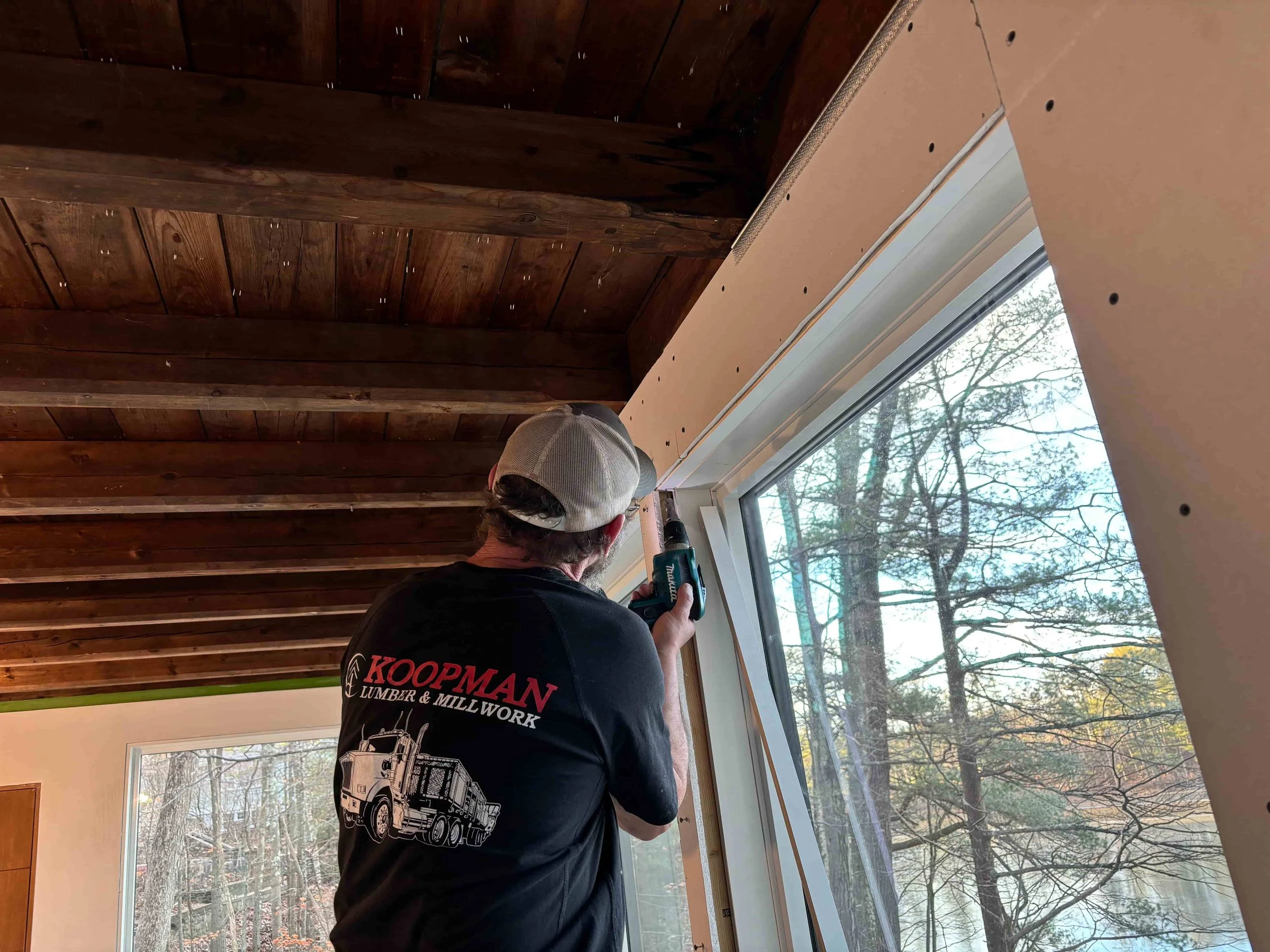 Contractor installing drywall