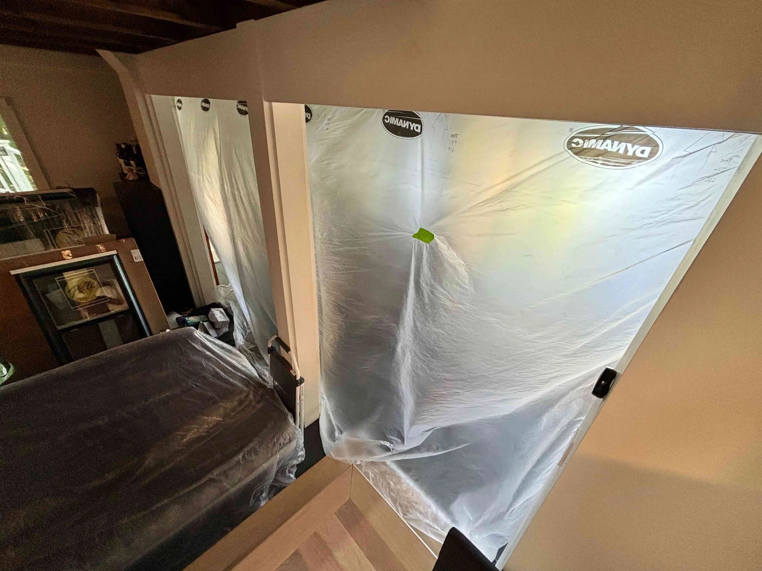 Area secured with sheet wrap to contain dust