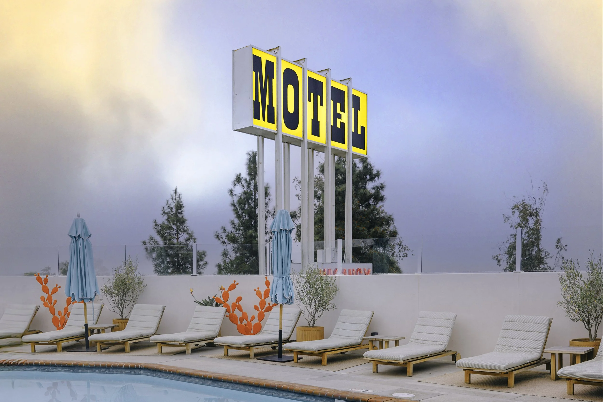 The pool area, and yellow motel sign, at the Skyview Hotel Los Alamos, California.