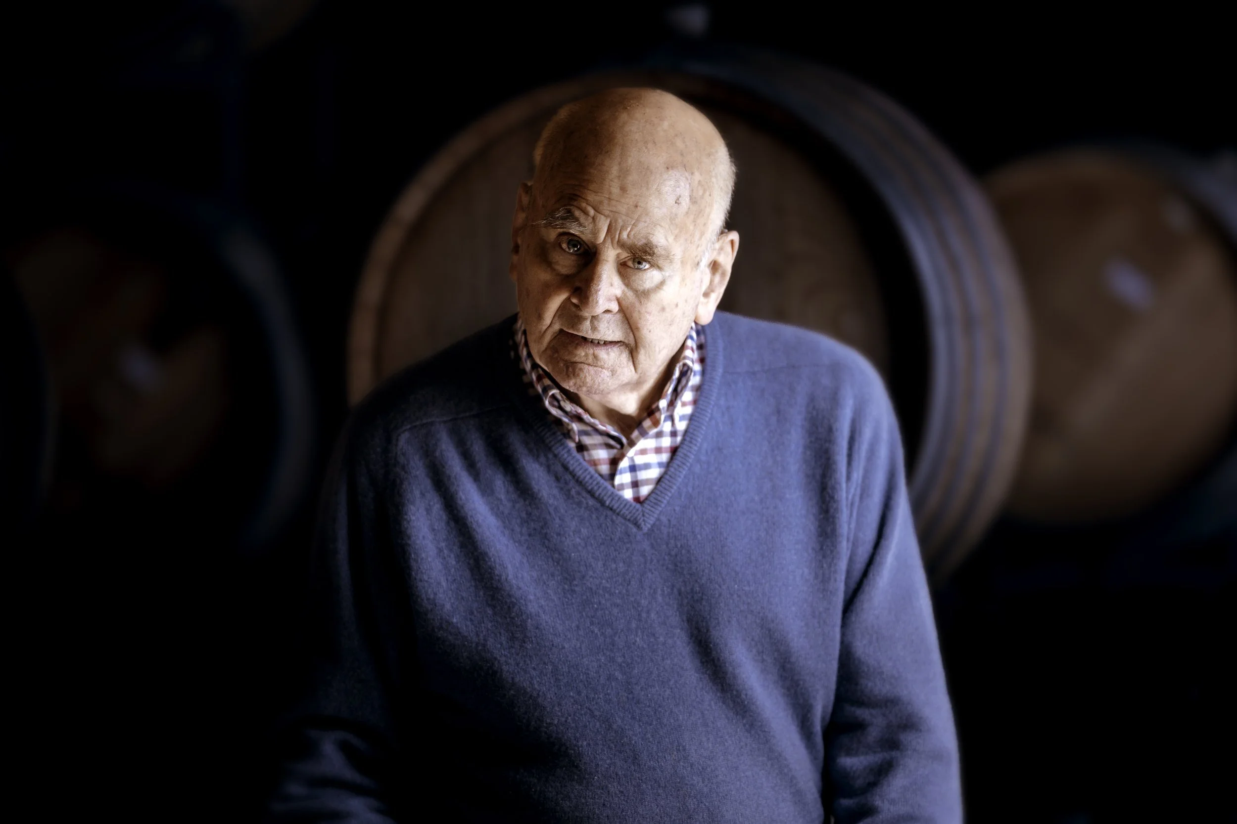 Wine legend James Halliday stands in the Coldstream Hills cellar and looks straight at the camera.