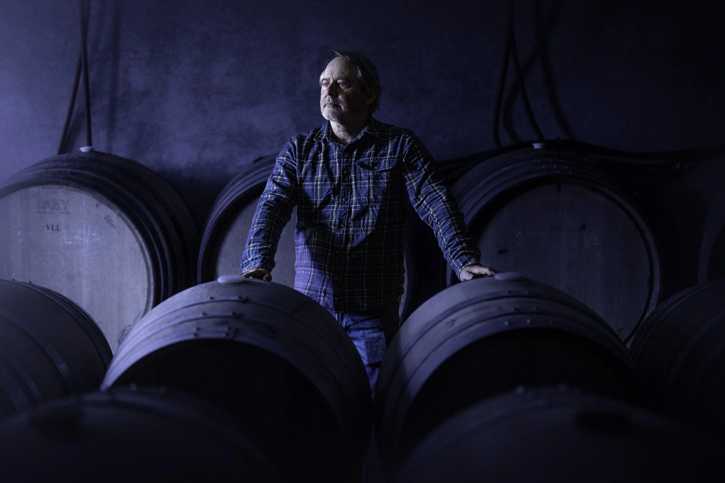 Winemaker Steve Lubiana, of Stefano Lubiana Wines, in the barrel room at the winery. staring towards the light.