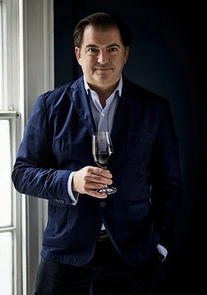 British wine writer Matthew Jukes, standing holding a glass of red wine. He died at 58.