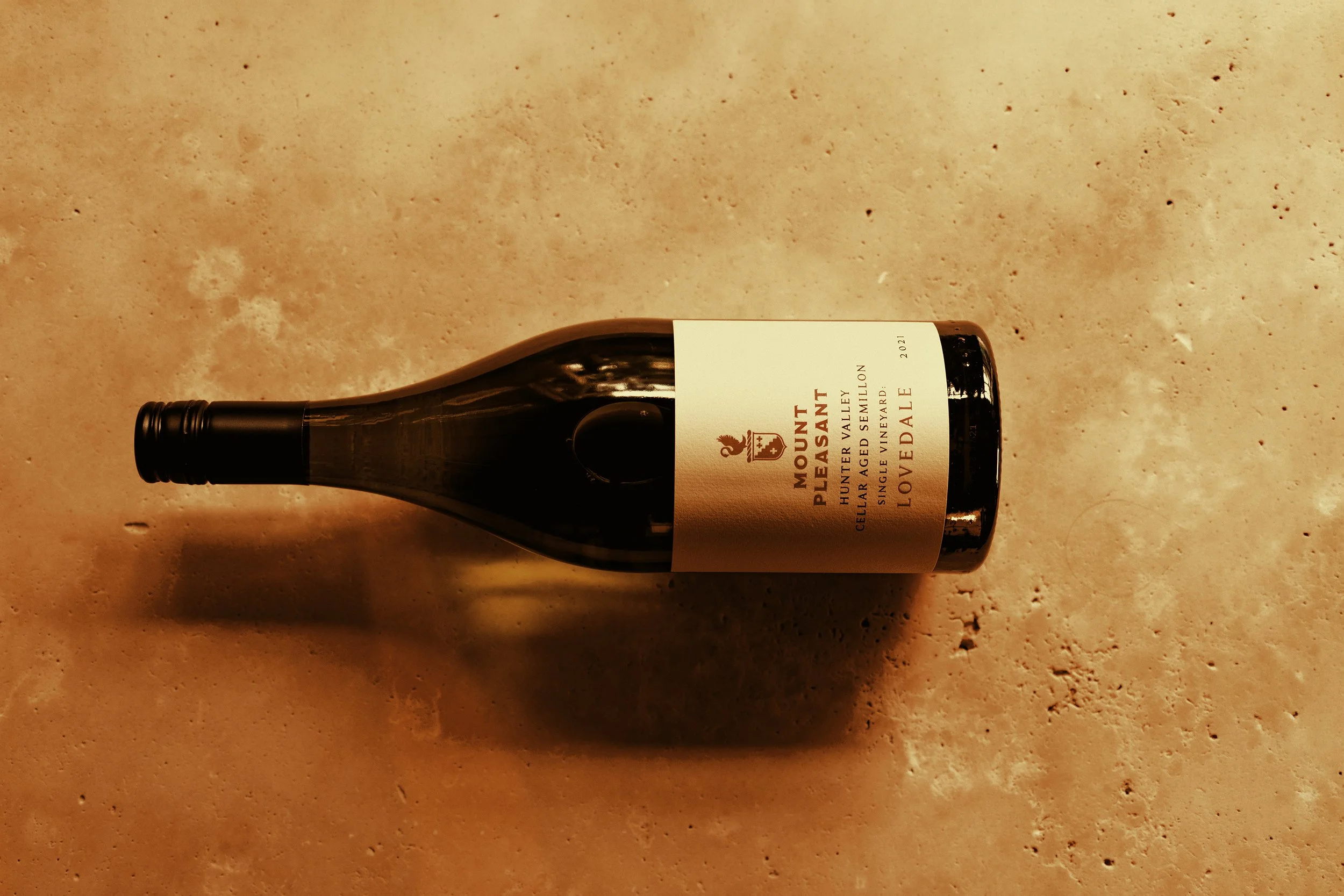 Bottle of Mount Pleasant Cellar Aged Lovedale Semillon 2021  on a clay background.