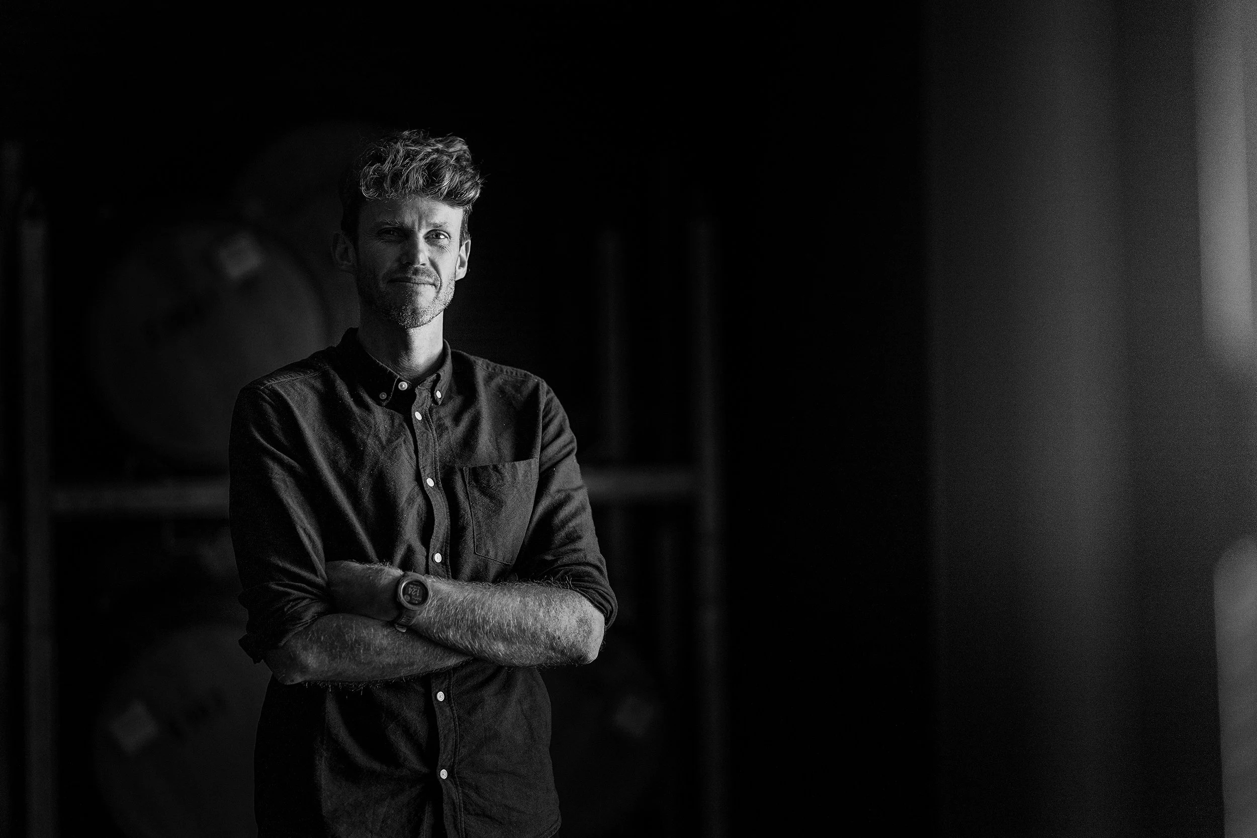 Julian Grounds, winemaker at Stonier, looks straight at the camera, standing in the Stonier winery.