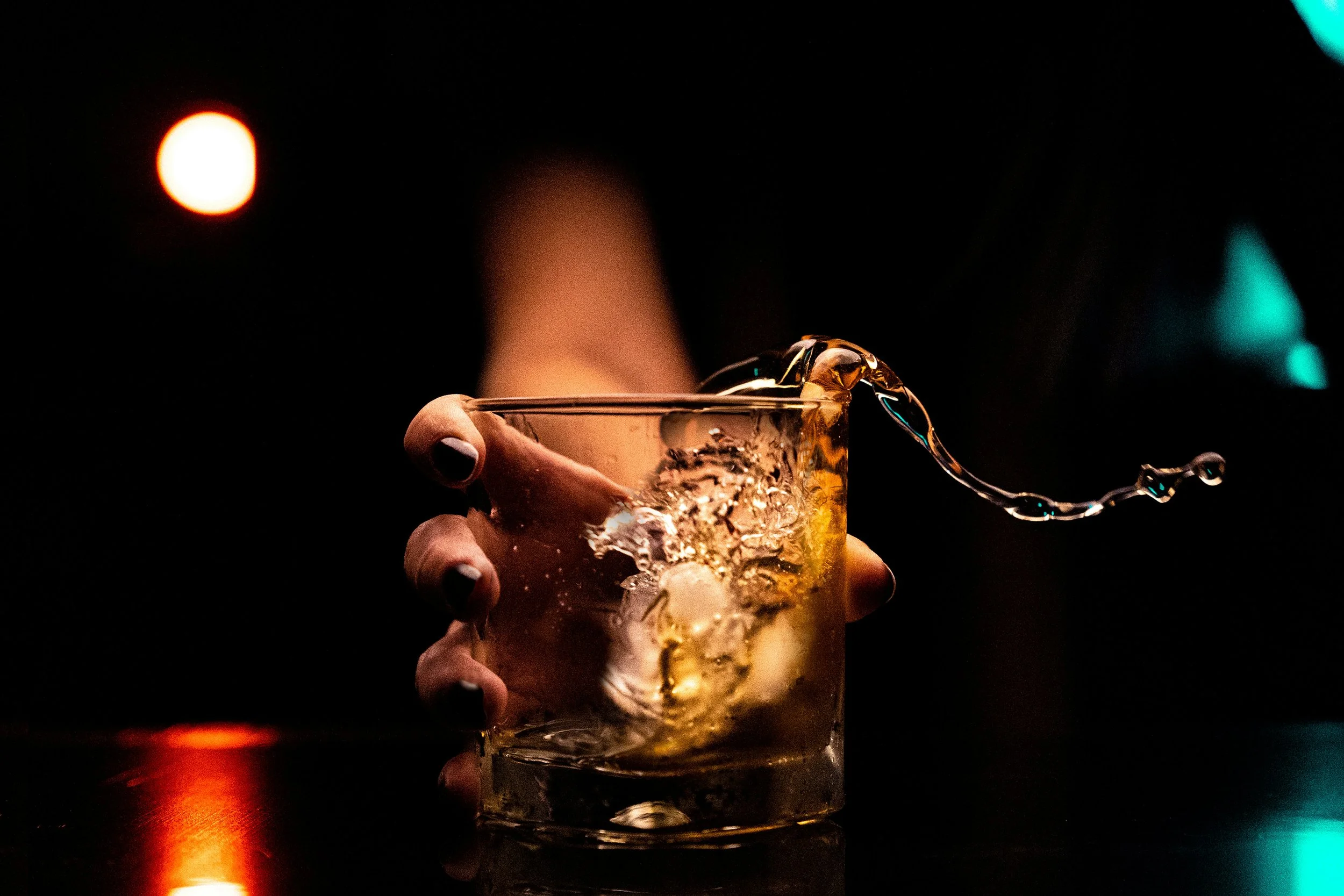 Picture of expensive whisky by swirled/splashed from a whisky glass.