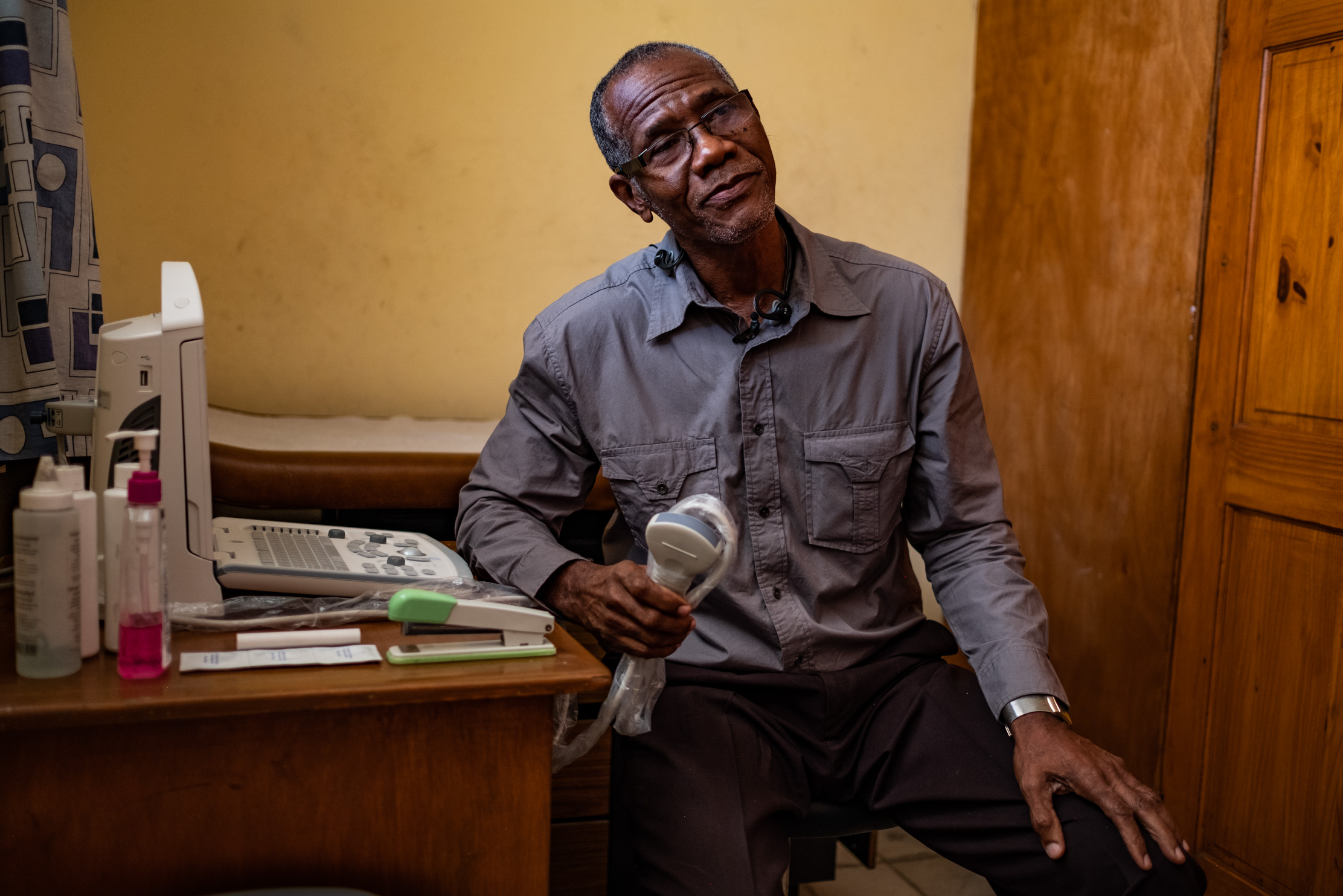 Dr. Arold Scutt, Medical Director of Centre Médico-Social Petite Place Cazeau since 1991, sets up his new ultrasound machine for the first time. He expects to retire in the next year or two and is proud he was able to add this life-saving technology to his legacy.