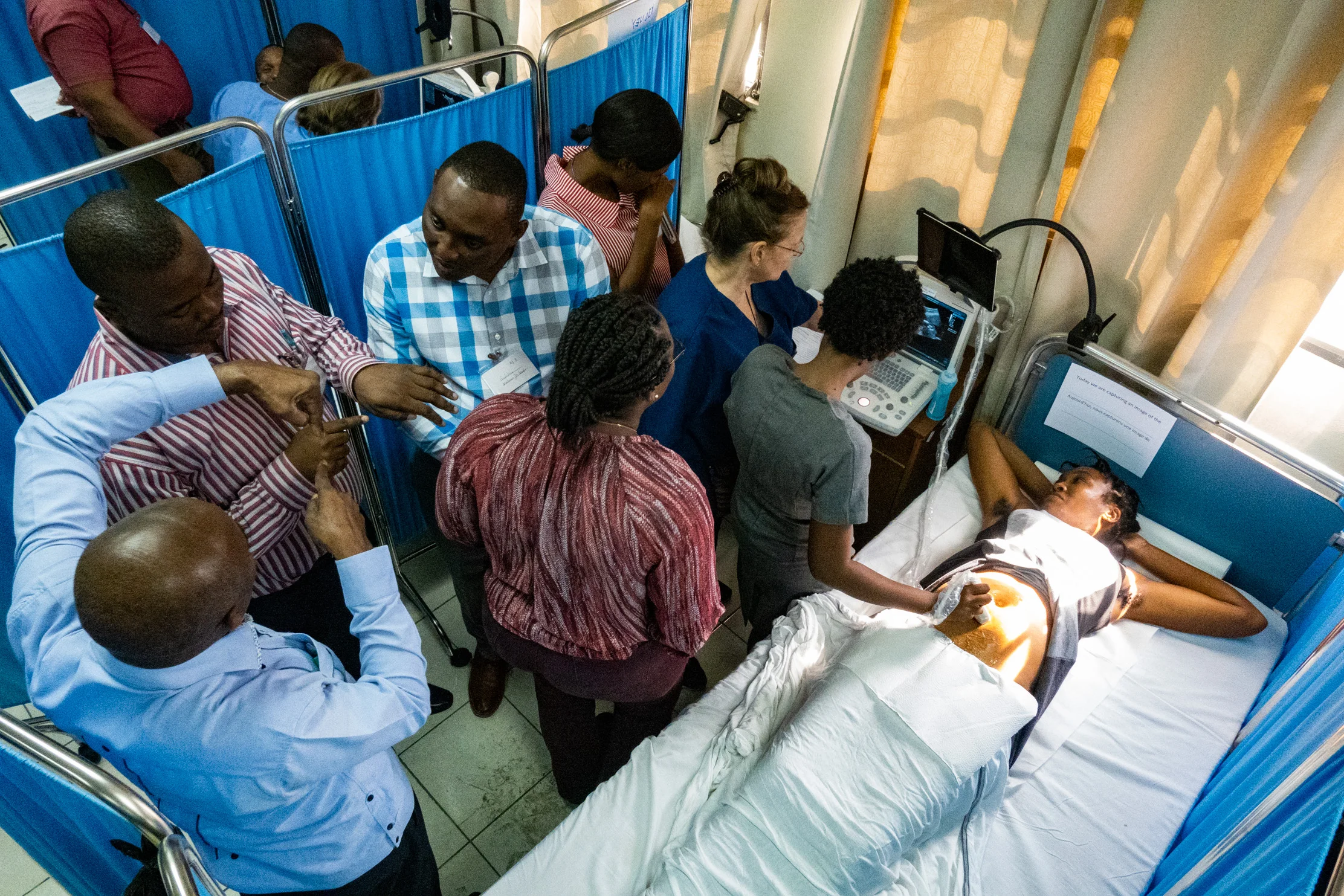 International OB/GYN, sonographer, and NYAGI veteran, Alecia Martin-Hirsel, steps aside as her group of Haitian doctors and nurses take over the probe, exploring and teaching themselves and each other.