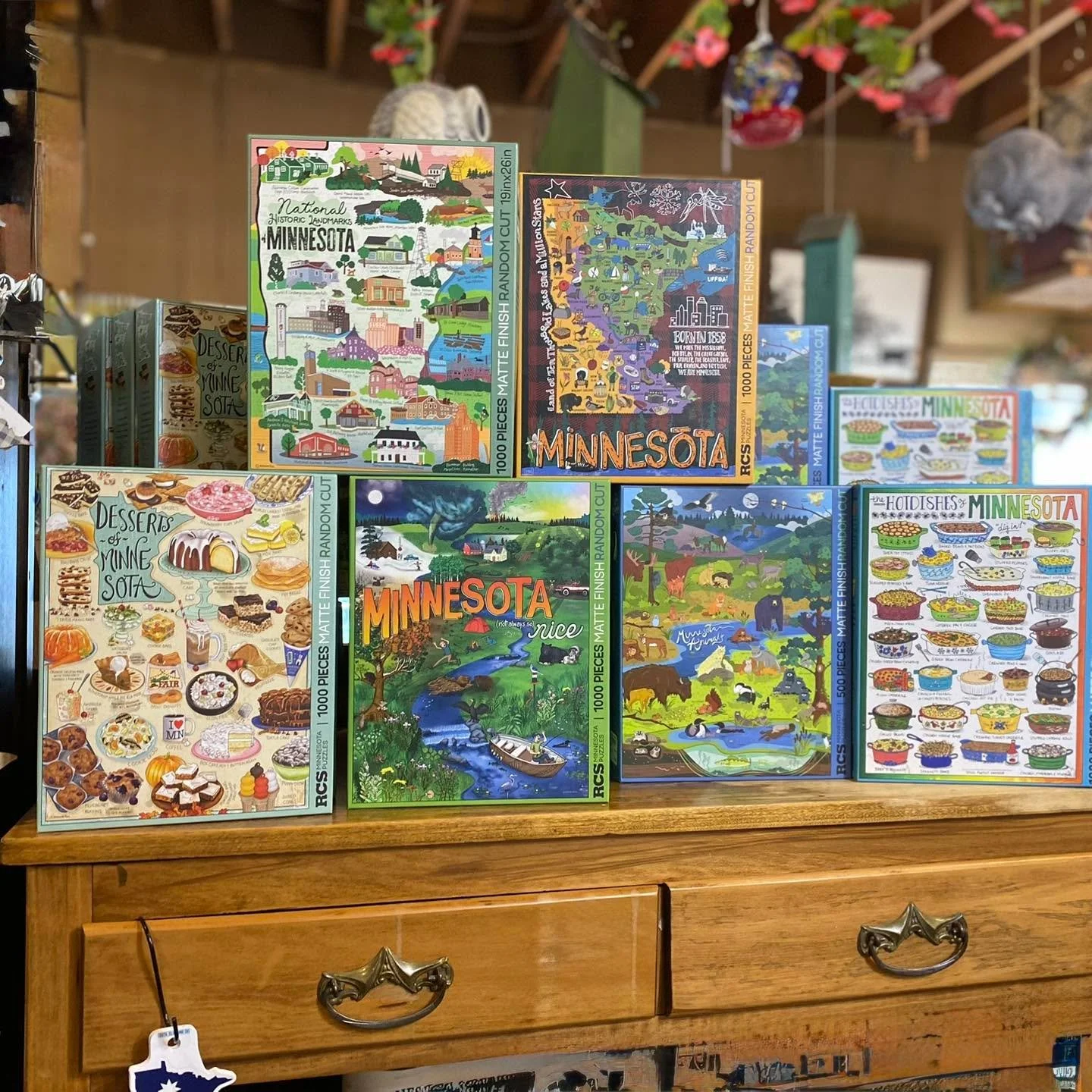 You guys always do a great job supporting local - here we go again!!! The whole collection has been restocked!!🧩😄👏🏼
Everyone is loving the humor, nostalgic, creative art from LOCAL( Walker, MN ) ARTIST, Melanie Rice. 
A smooth matte finish and al