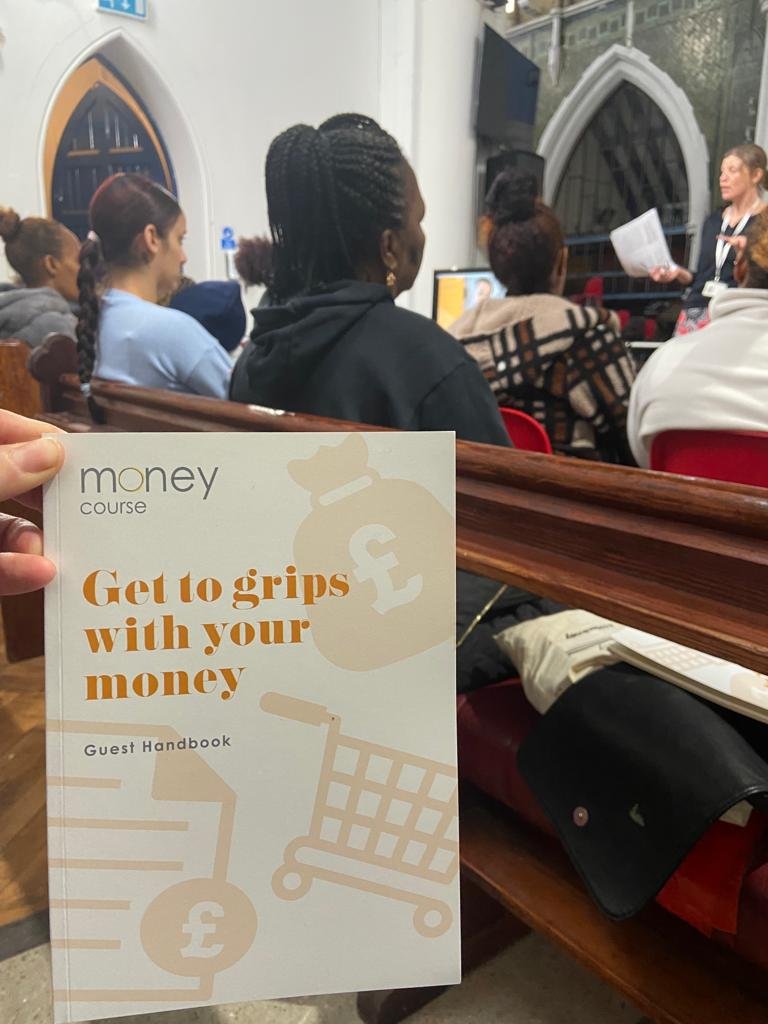 Money_course_booklet_with_women_in_background.jpeg