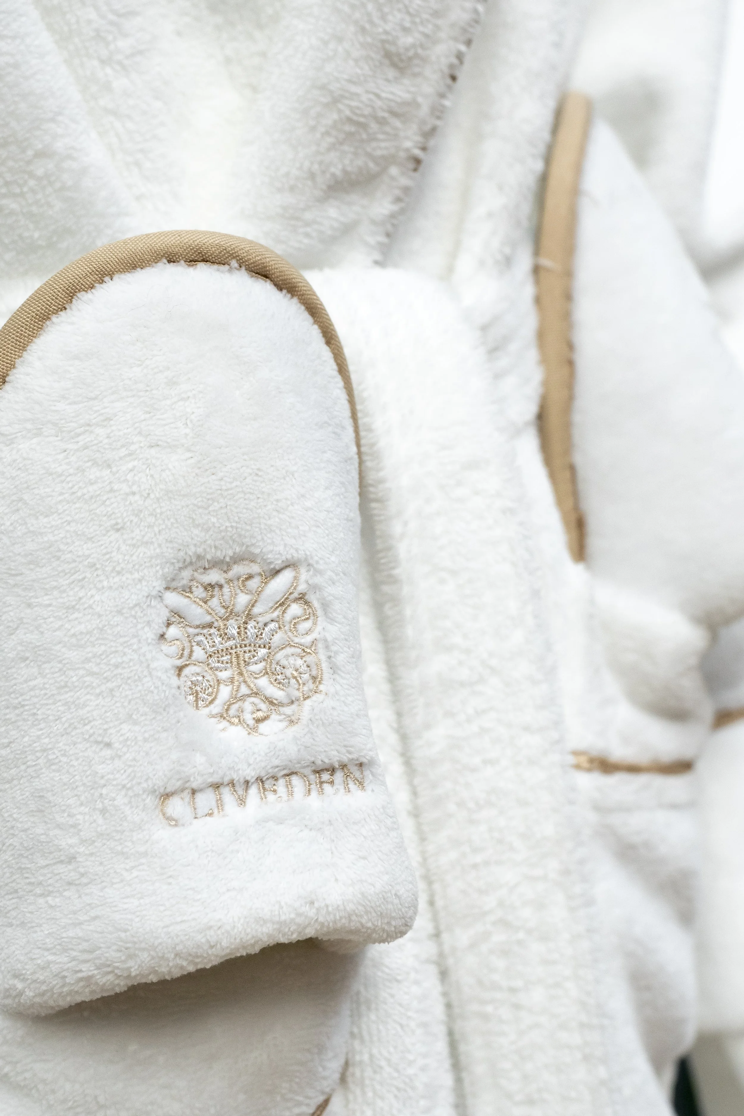 White bathrobe with an embroidered gold-trimmed crest_Cliveden House and Spa