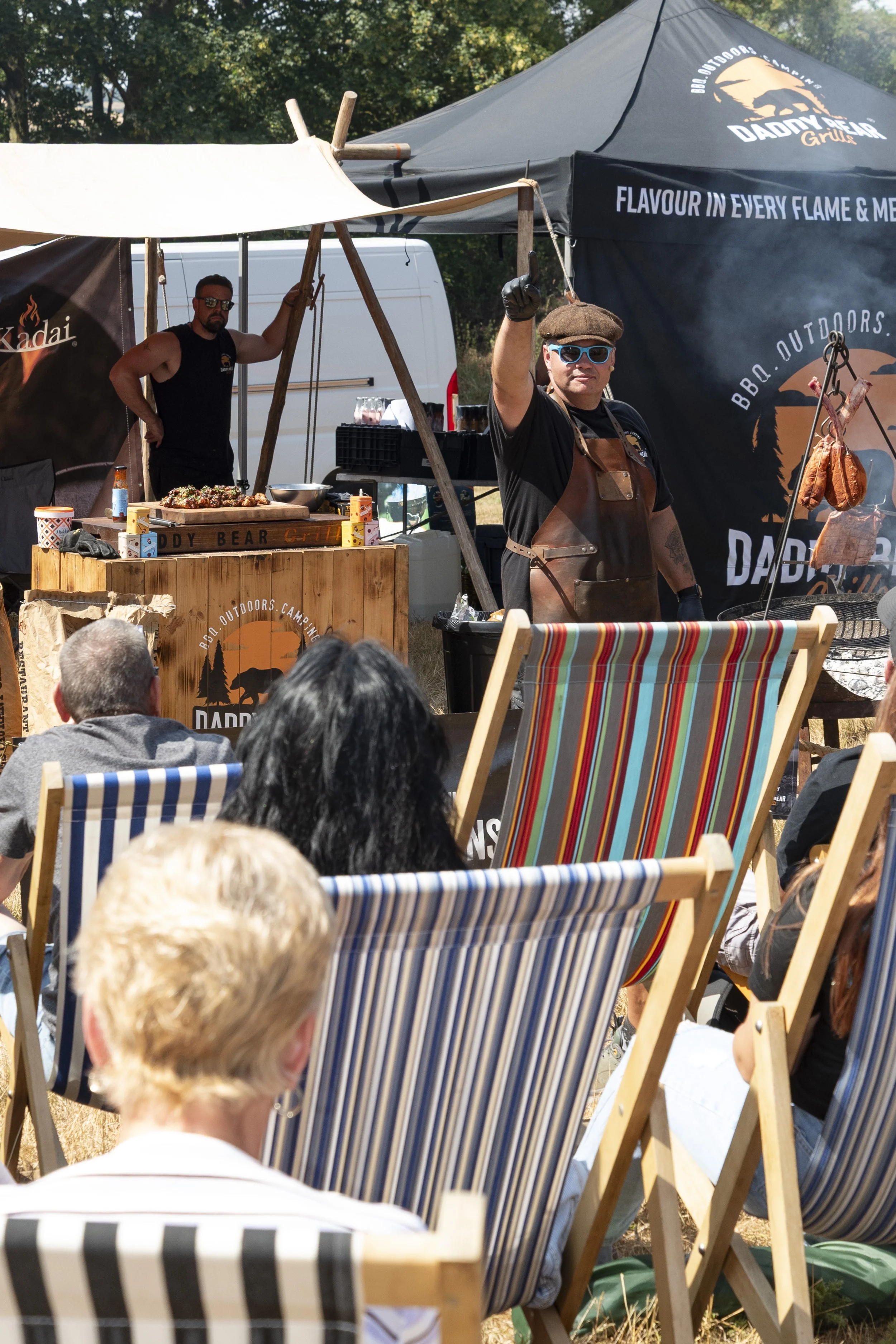 Event food stall vendor demonstrating culinary prep at the Great British Food Festival 