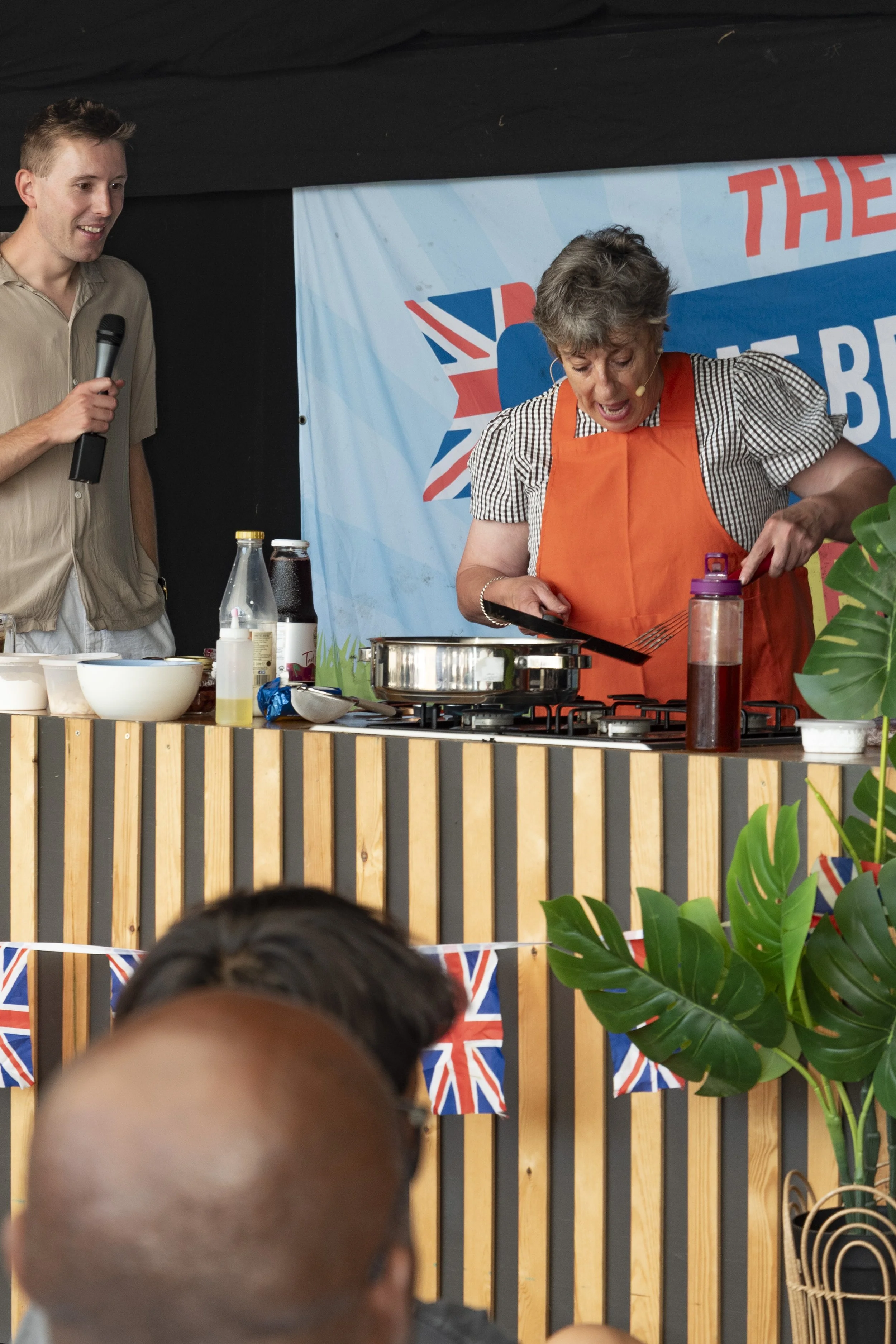 Event food stall vendor demonstrating culinary prep at the Great British Food Festival 