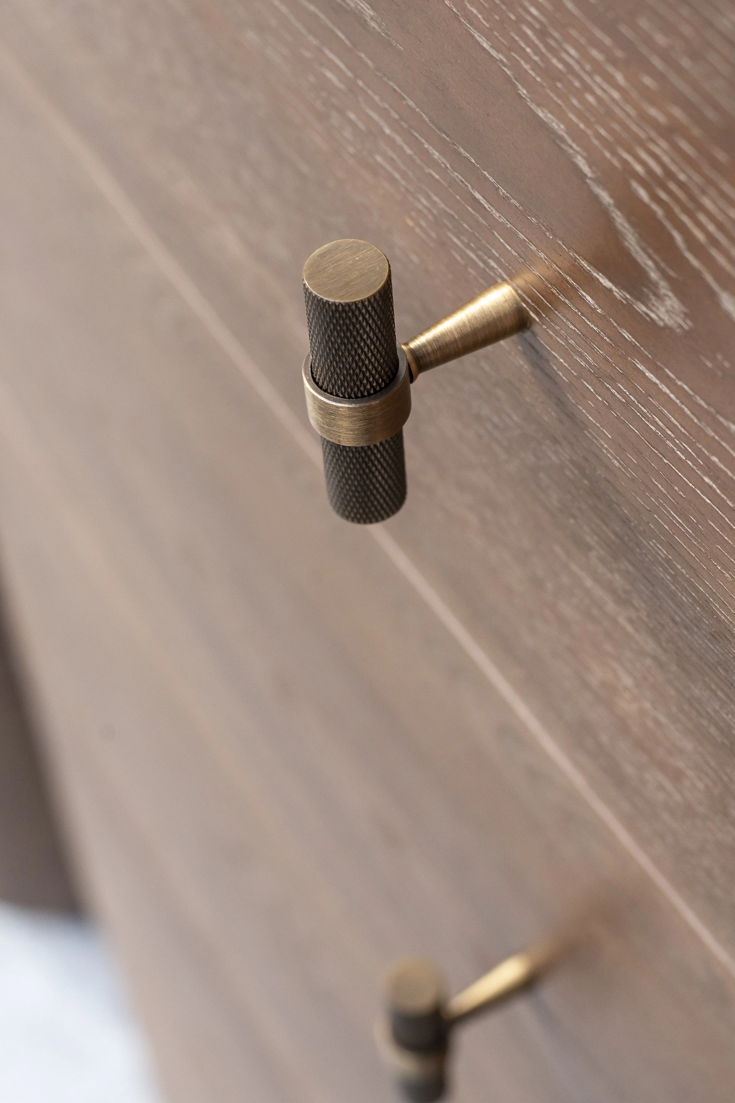 Brass knob on a dark wood drawer_VIDA Living