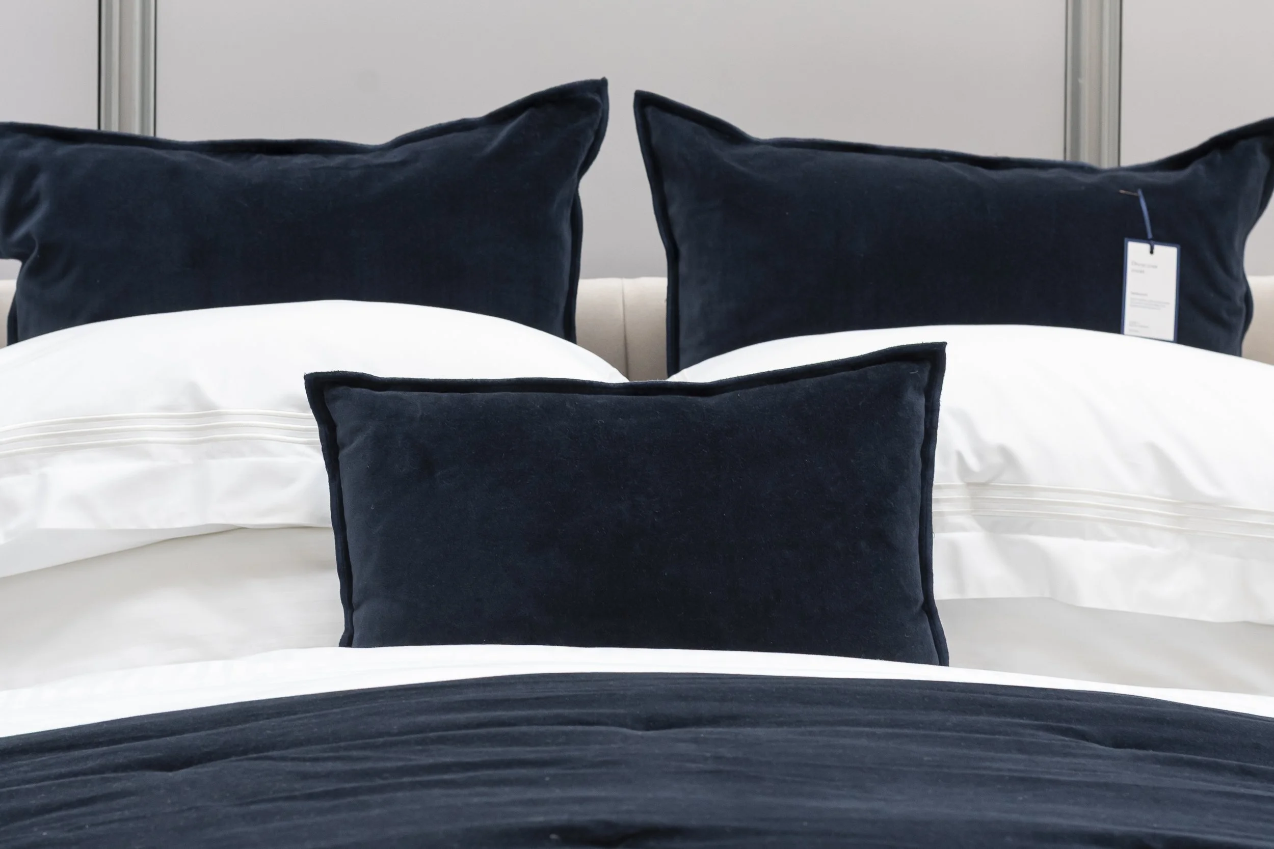 Navy velvet cushions on white bed linen_Christy
