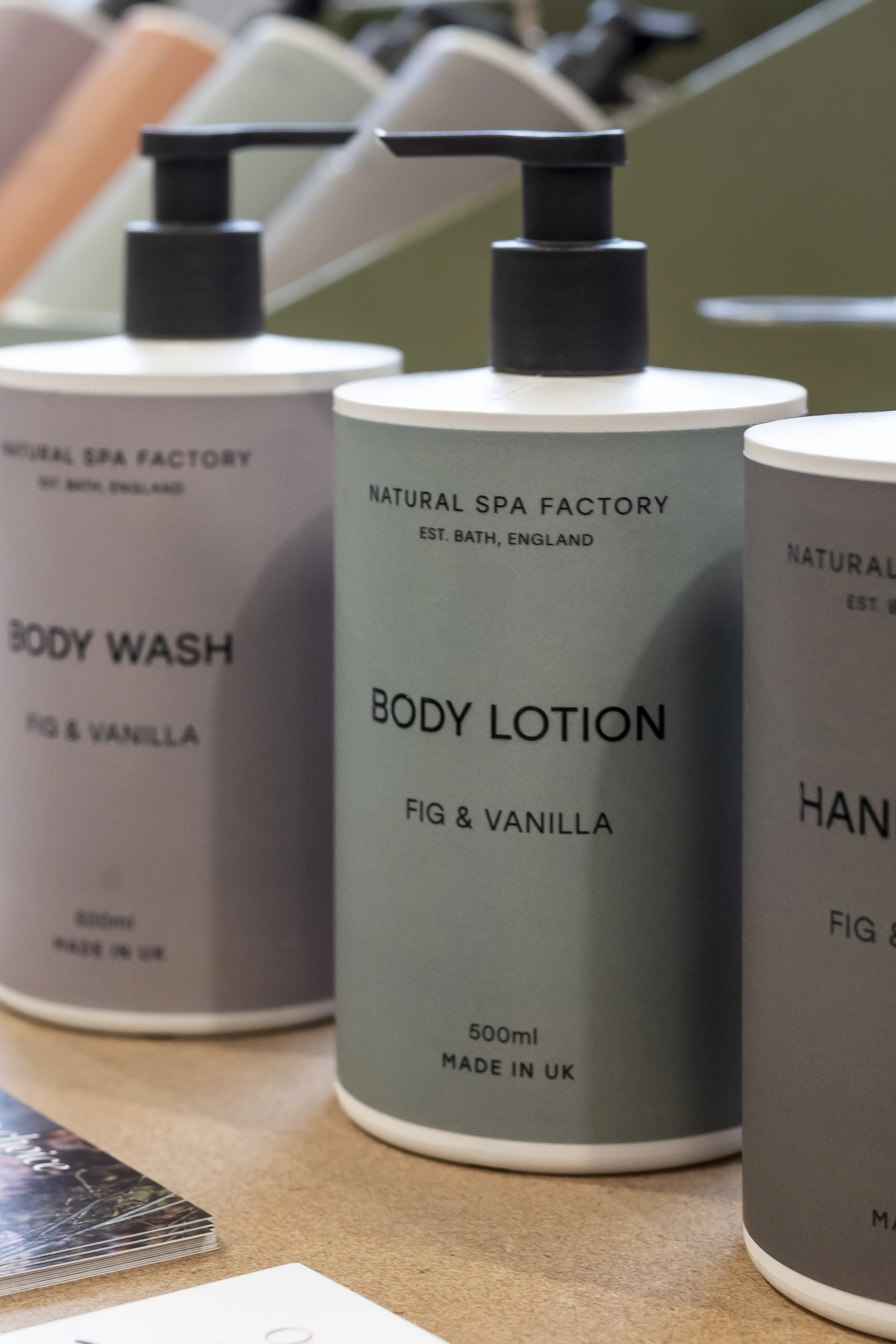Grey pump bottles of hand wash and body lotion on a tray_Natural Spa Factory