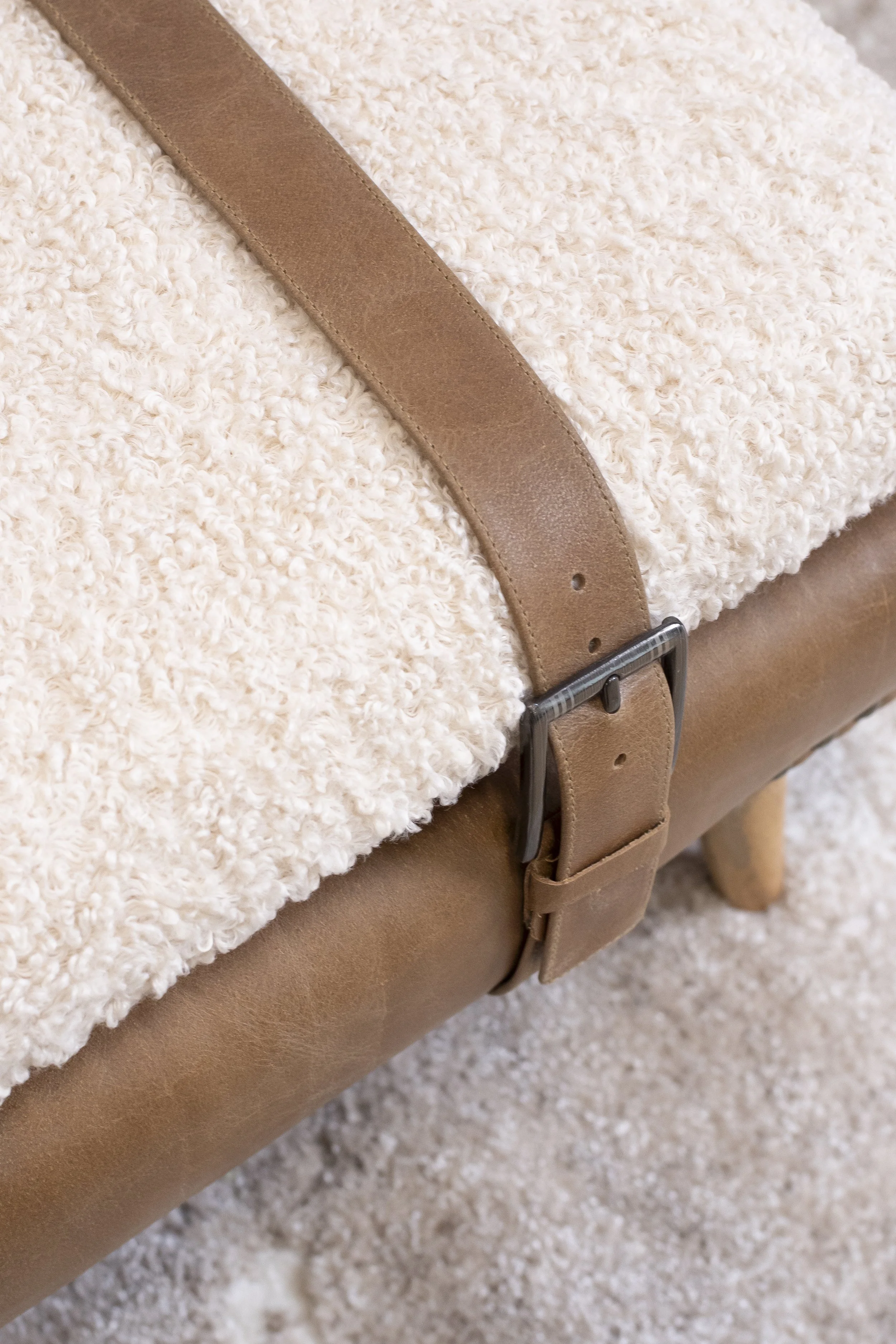 Cream wool throw with a tan leather strap_Wayfair Professional