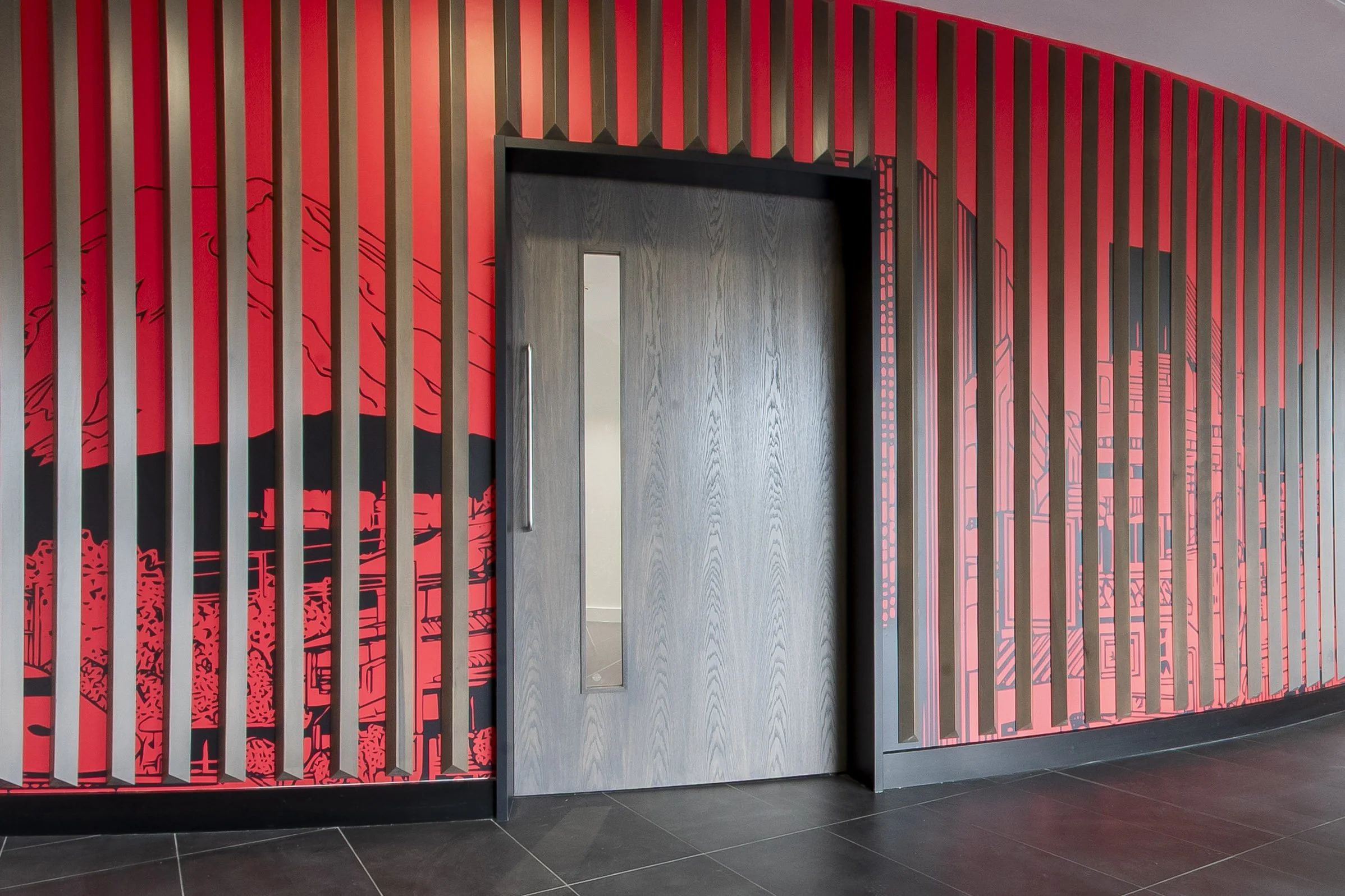 Feature wall of red vertical slats with a grey wood-effect door