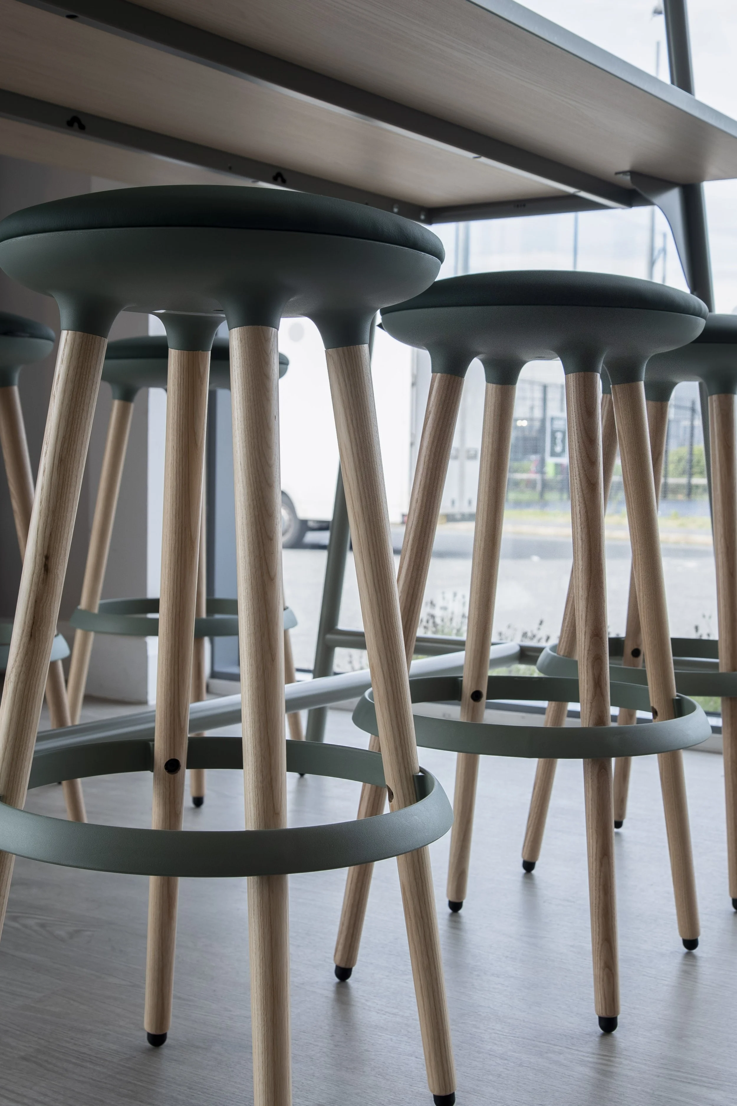 High stools with timber legs at a raised table