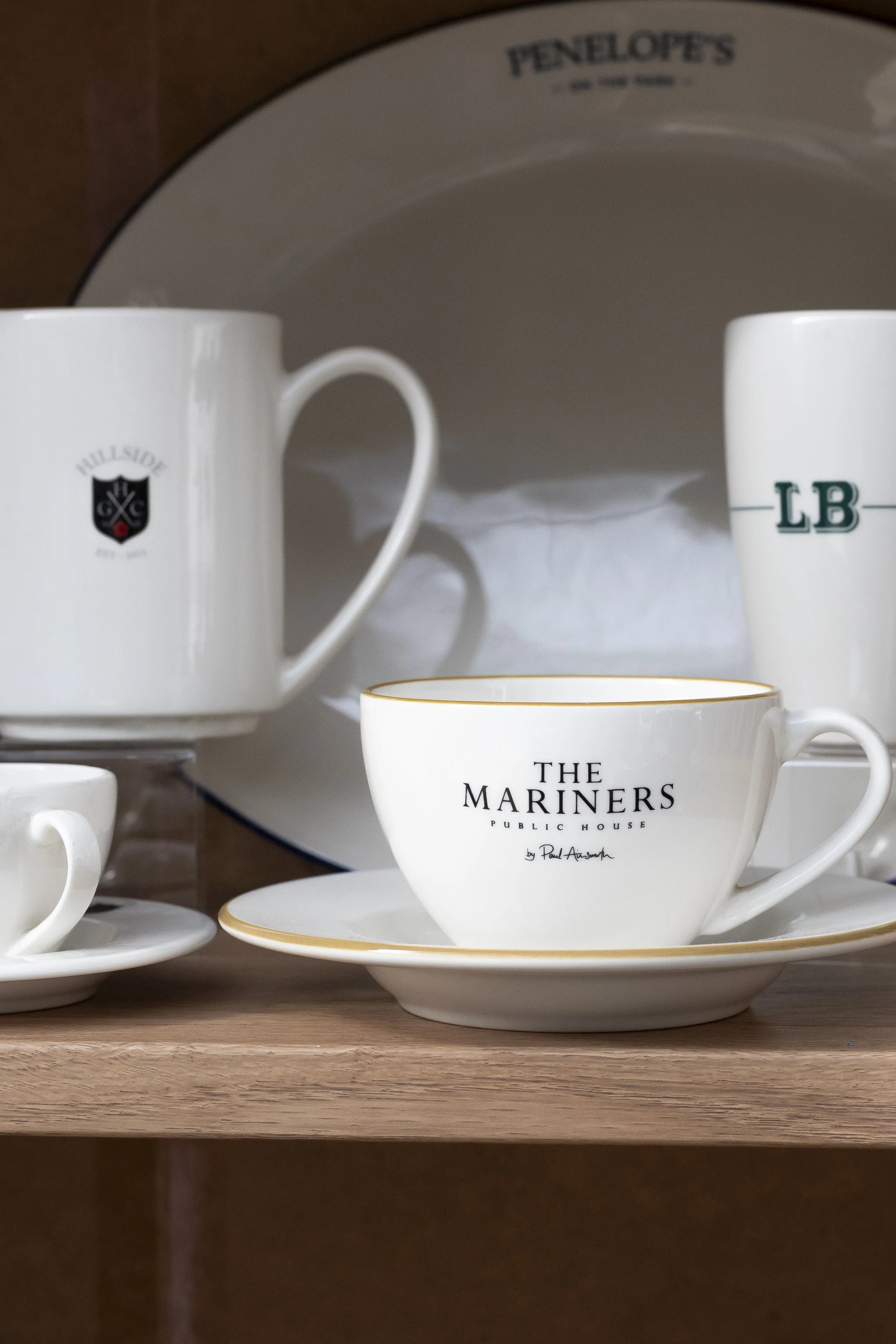White teacups and saucers on a wooden tray_HG Stephensons Ltd