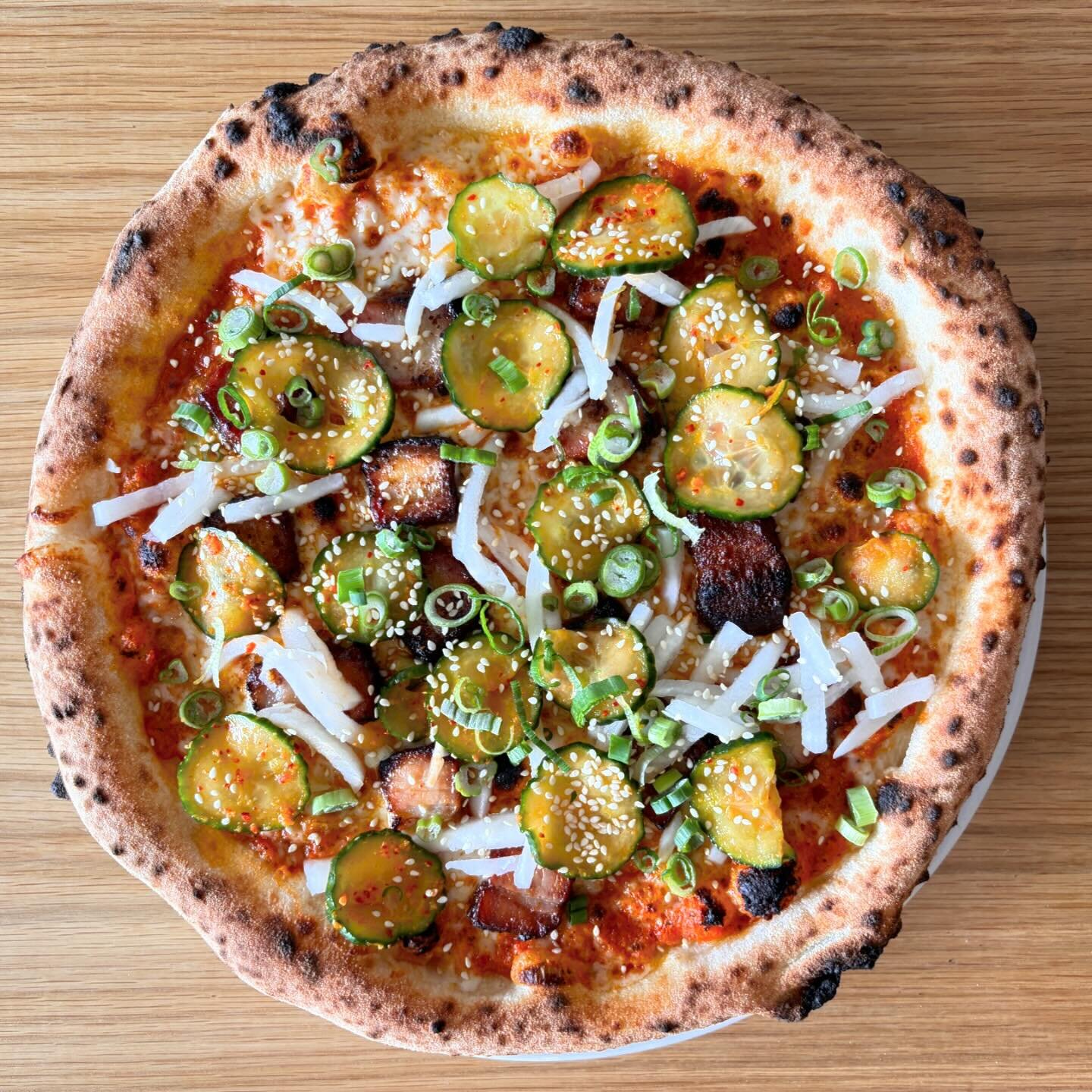 Introducing our newest // Korean BBQ Pizza

Gochujang Romesco sauce, mozz, smoked gochujang pork belly, pickled radish, Korean marinated spicy cucumbers, green onions, and toasted sesame seeds

The perfect blend of smokey and sweet 👌🏽

Now availabl