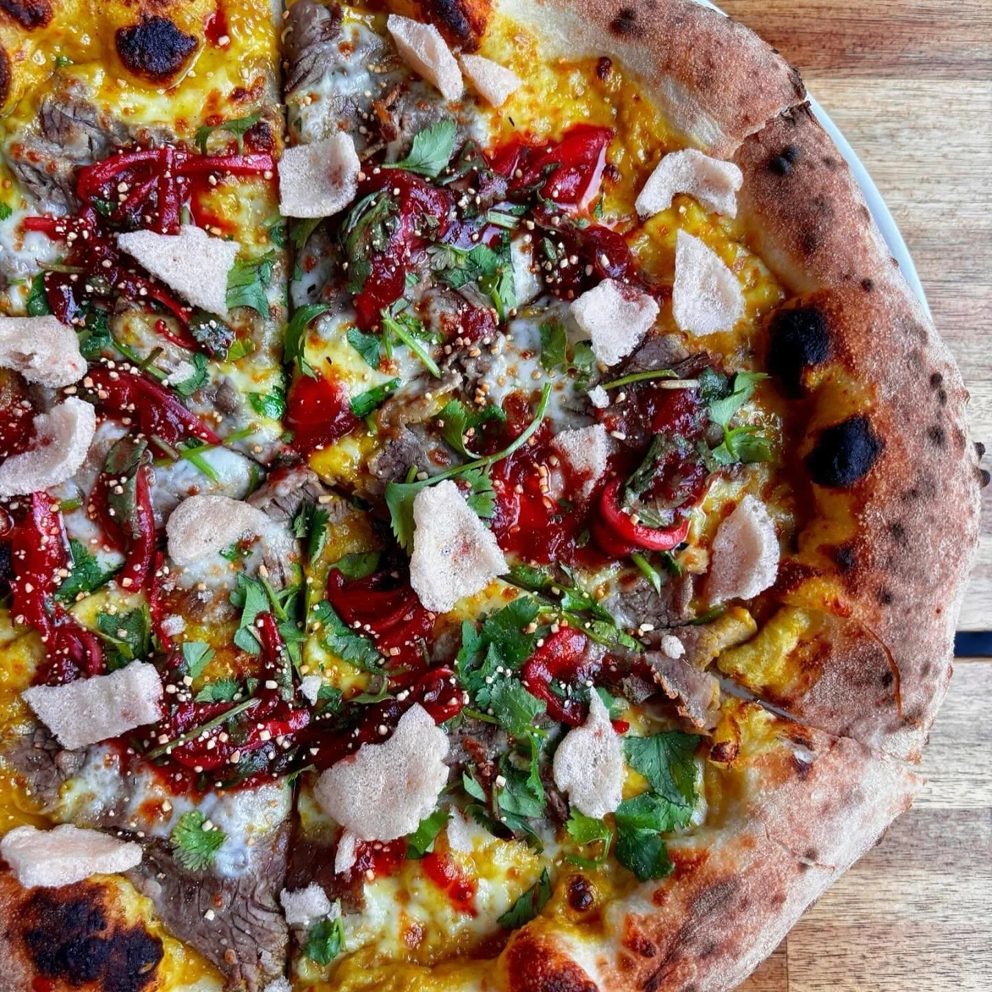 Bringing back &mdash; Lamb Curry Pizza 

// Indonesian inspired spicy curry, lamb, mozz, cilantro, cranberry jaew, roasted rice, and tamarind shrimp chips.

With a fall-inspired fruit twist to the jaew (a Thai dried chili sauce), this pizza hits the 