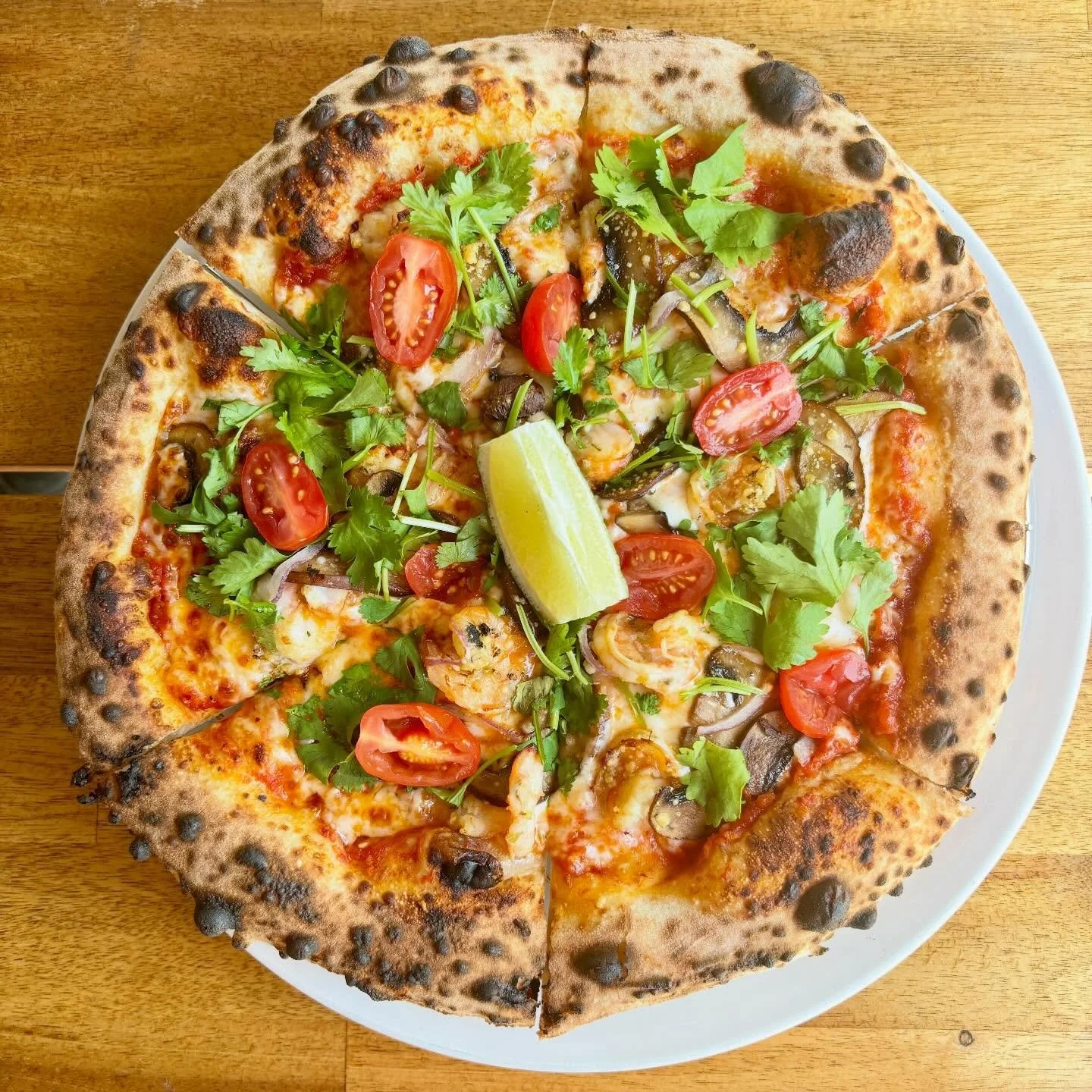 New to the menu &mdash; Tom Yum Pizza 🍤🍋&zwj;🟩🌶️

House-made tom yum red sauce, mozzarella, garlic shrimp, saut&eacute;ed mushrooms, cilantro, tomatoes, crispy onions, and a fresh lime squeeze.

This was one of the pizzas from our grand opening 3