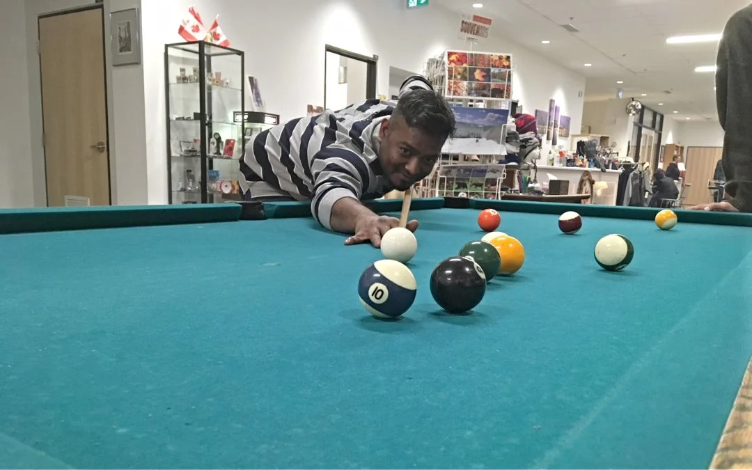 Relaxing with a game of pool. The Sea Chest store is in the background.