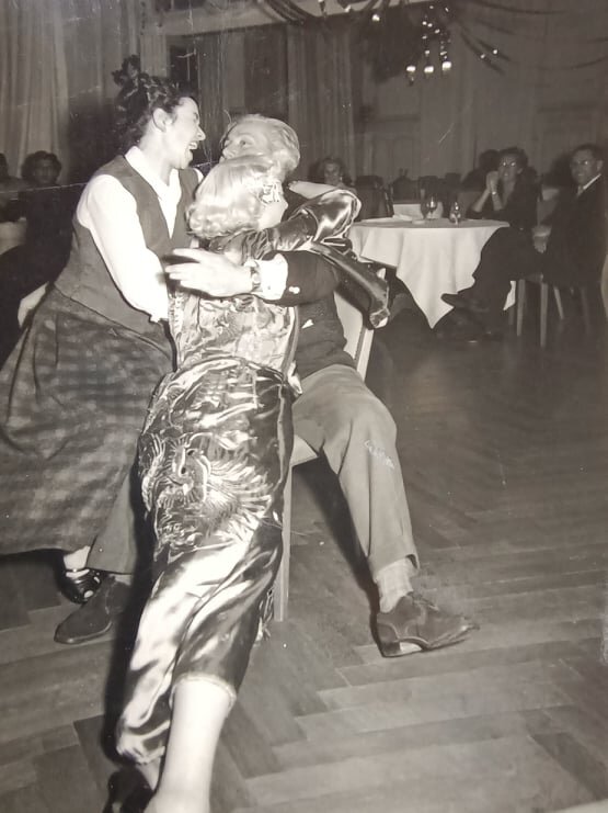 black and white photo of a man and two women dancing.jpg
