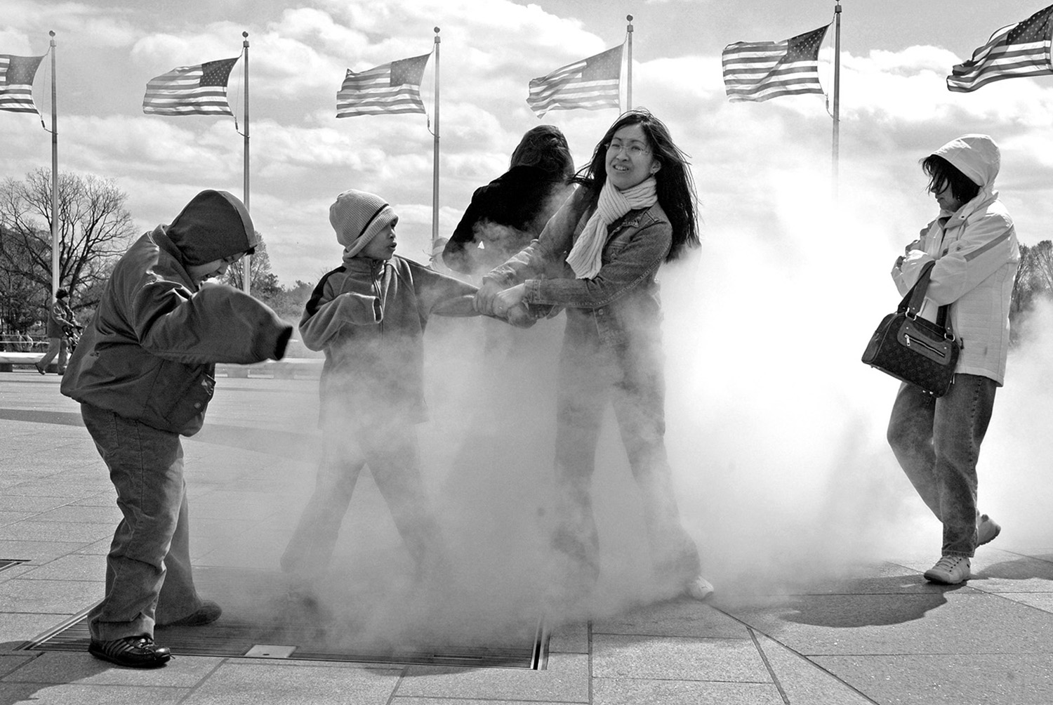 Tourists_Washington_Monument_Winter_Steam_Grate_Siblings_American_Flags.jpg