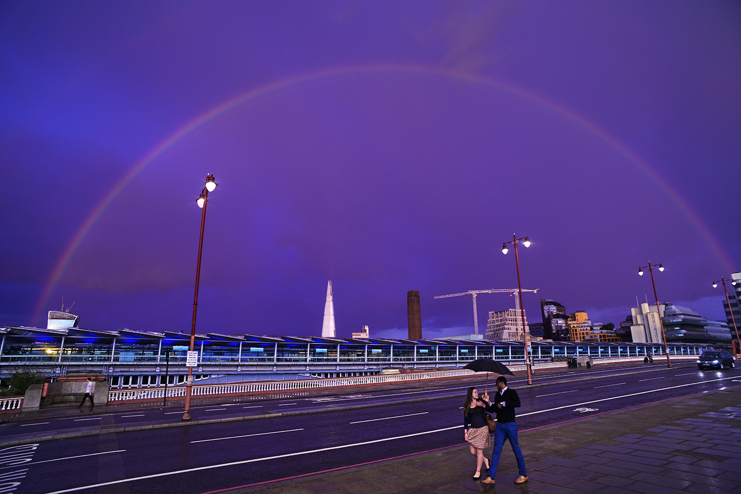 Under_the_Rainbow_London_Dusk_Raining_Umbrella_Couple_Walking_Bridge.jpg