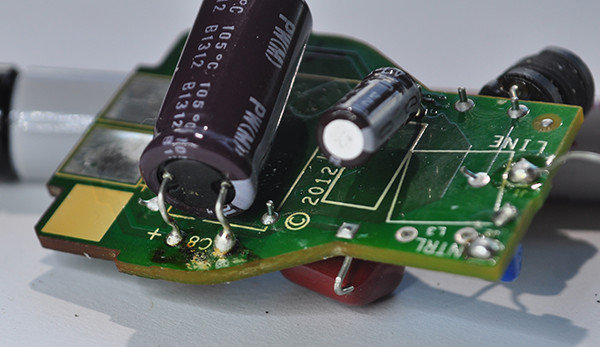Some crud around the right lead of the primary capacitor. May just be left over from manufacturing. The cap looks fine, no bulging or signs of leaking.