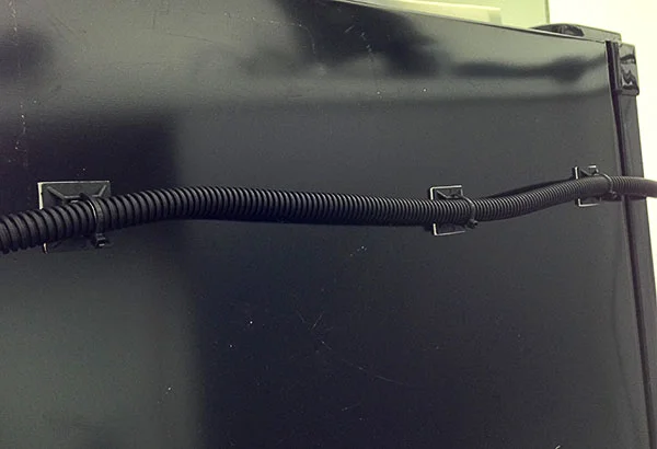 CAT5 cable inside split tube running to the front of the fridge.