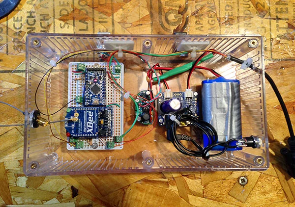 This was the first enclosure I tried. Not water/air tight but I just needed to protect everything from condensation. The Arduino and XBee are on the left. MintyBoost is on the middle-left and the solar charger is on the middle-right. The blue thing on the right is the battery, there is a temp sensor taped to is so the charger can decide if it’s too cold or hot to charge.