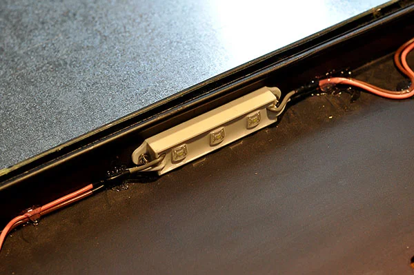 An LED module was mounted to the left and right sides of the number. Hot glue kept wires in place.