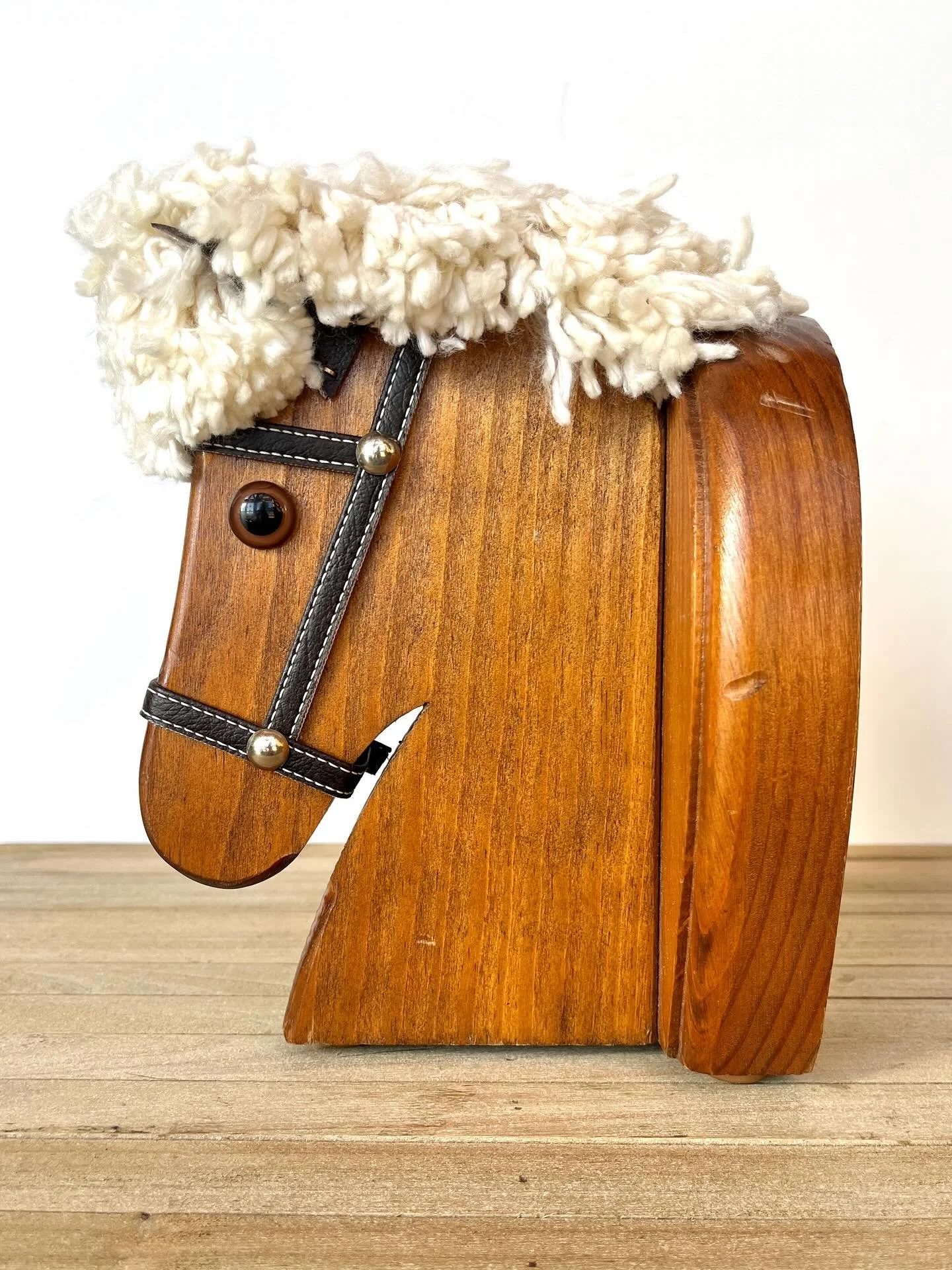 Adorable toy horse head with bridle and yarn mane. This would be a fun addition to a horse gallery wall or kids room decor. It could be hung on the wall, as shelf decor, or even used as a book end. Available in my online store - link in bio.