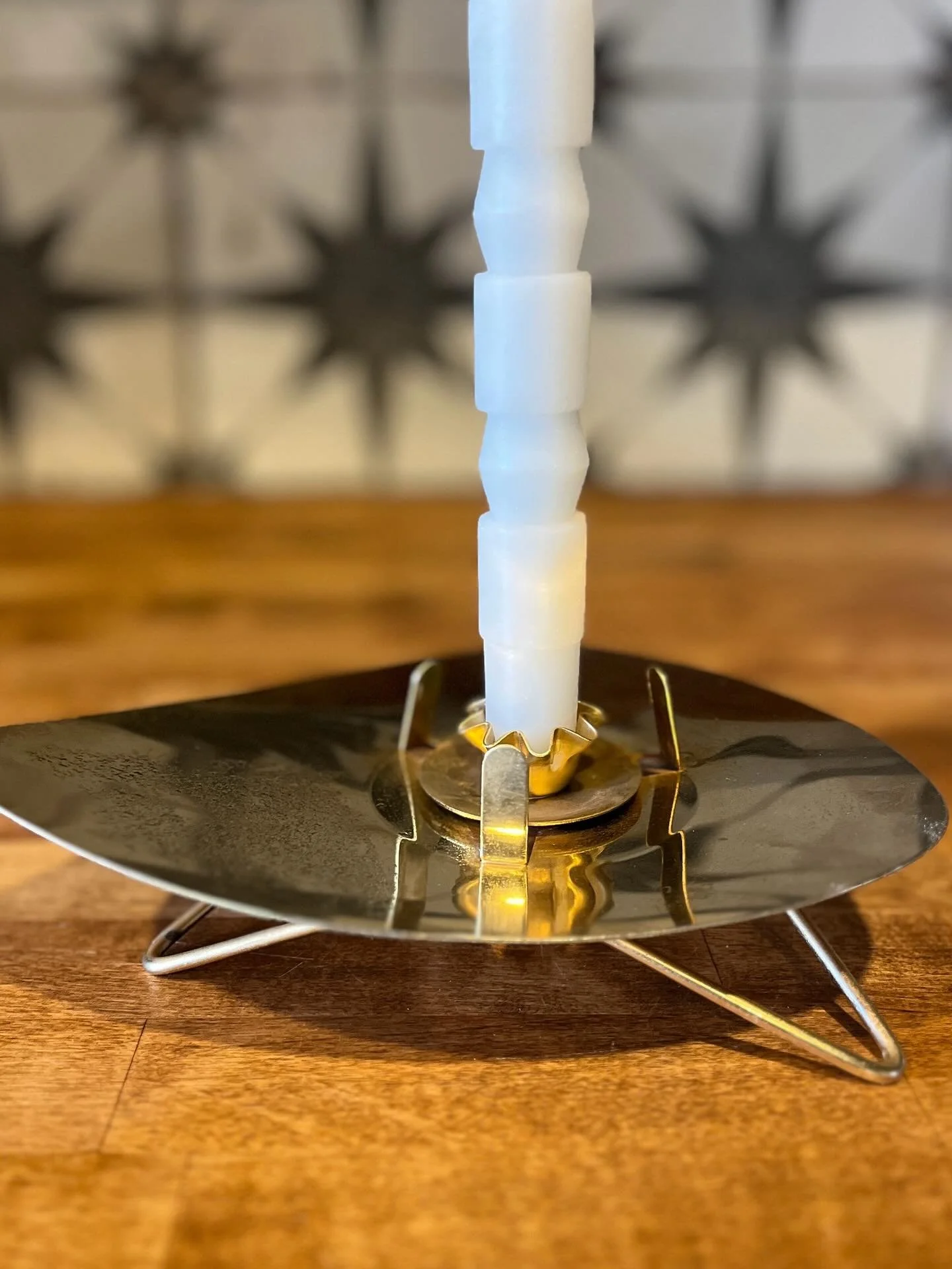 An MCM atomic brass candleholder. Available in my online shop - link in bio.