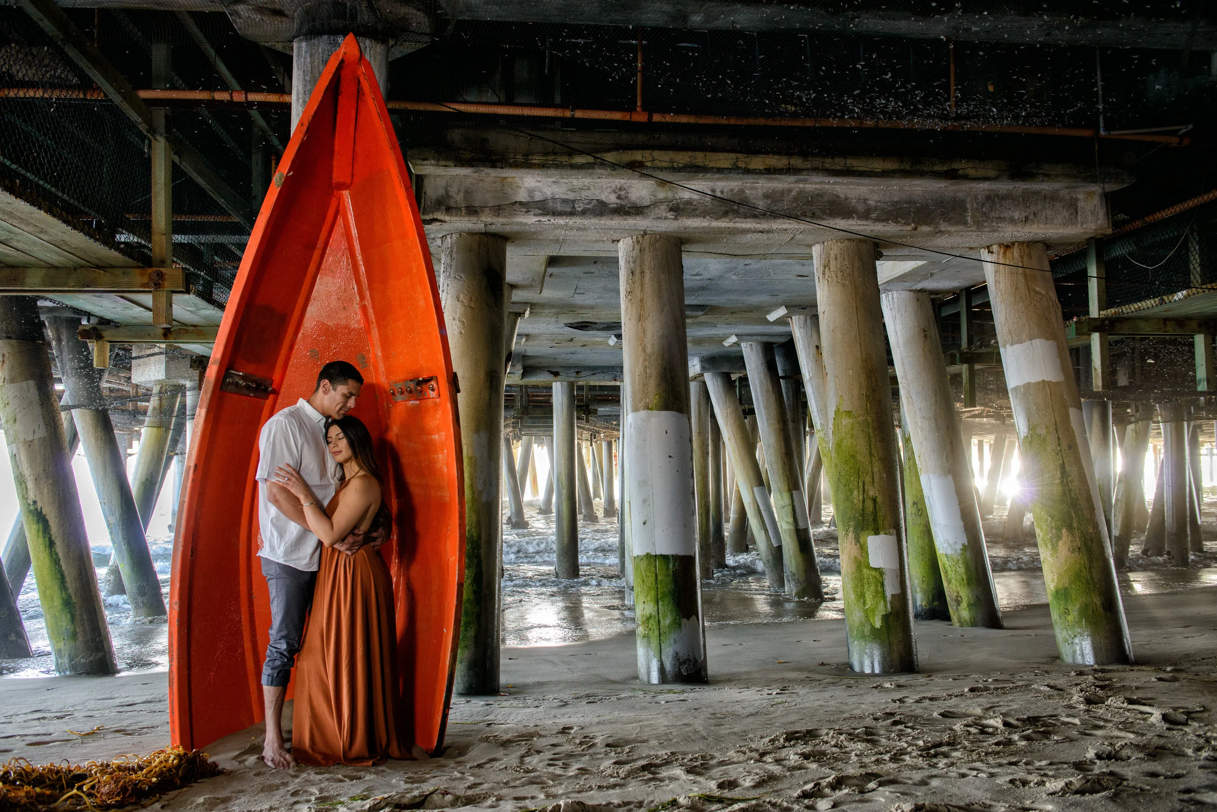 Beach Engagement at Santa Monica Pier With Red Boat